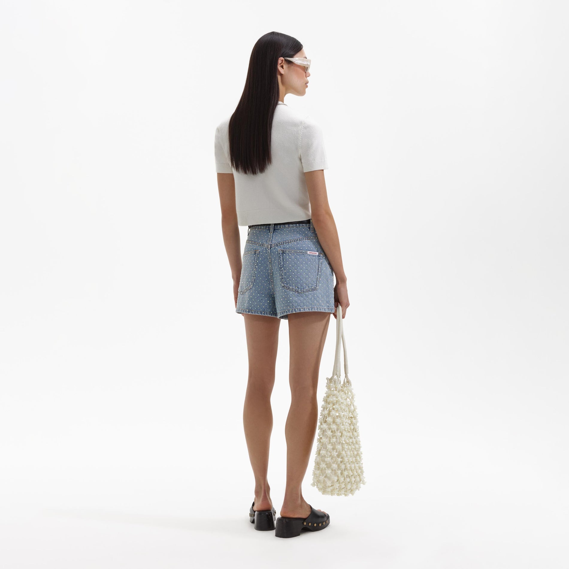 Back view of a woman wearing the Cream Cashmere Cardigan