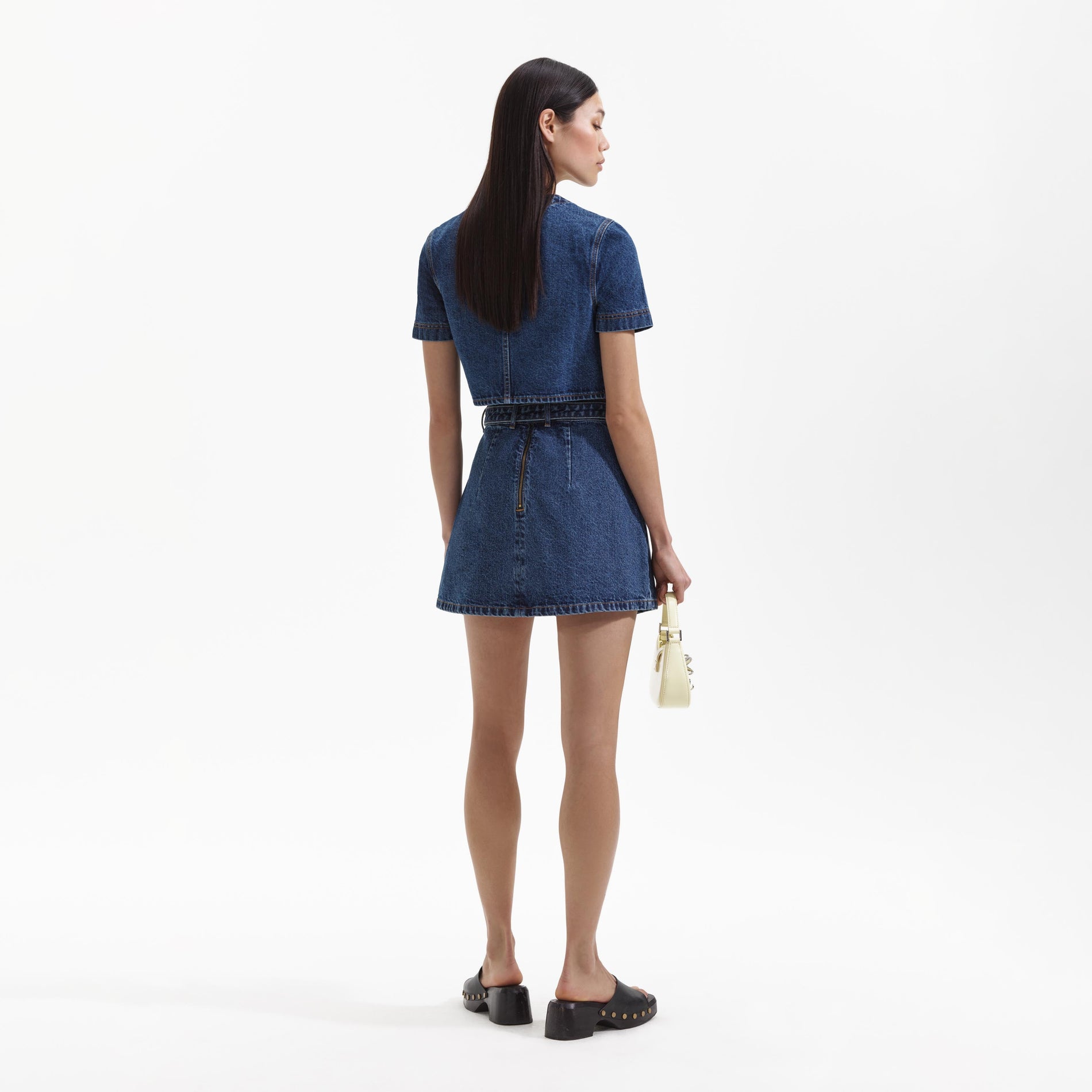 Back view of a woman wearing the Denim Short Sleeve Crop Top