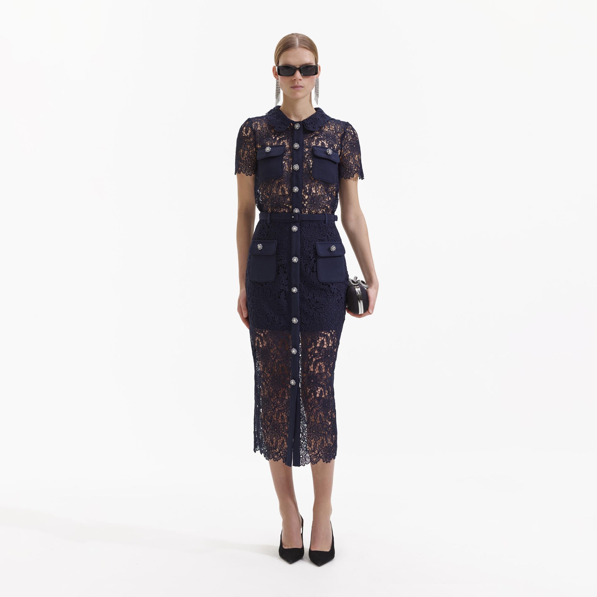 Front view of a woman wearing the Navy Guipure Lace Midi Skirt