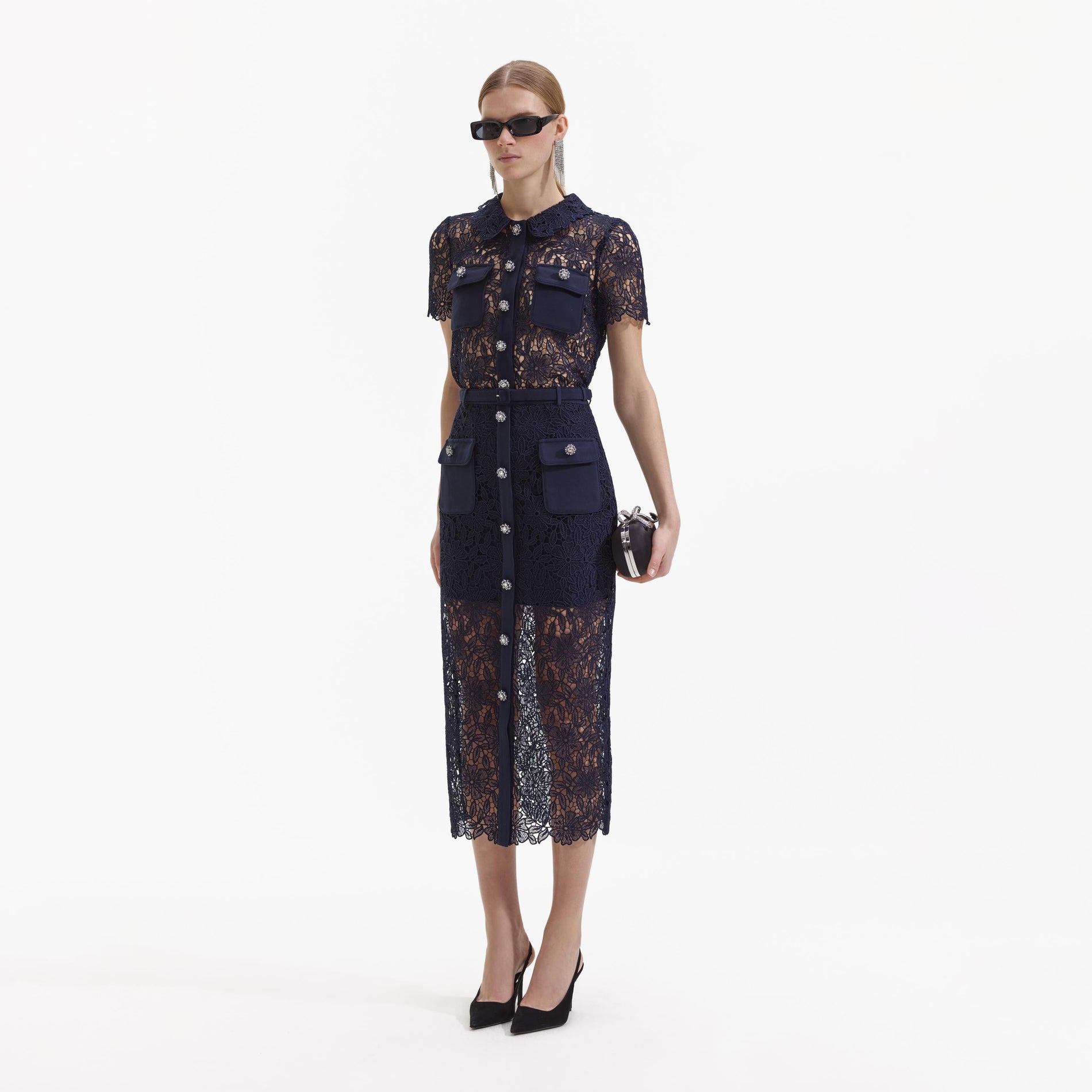 Side view of a woman wearing the Navy Guipure Lace Top