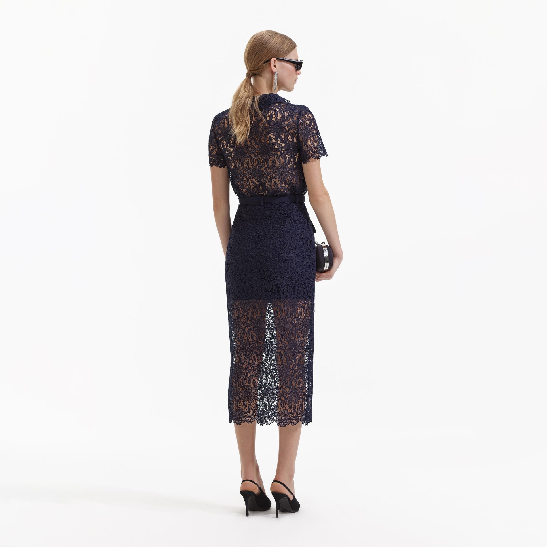 Back view of a woman wearing the Navy Guipure Lace Midi Skirt