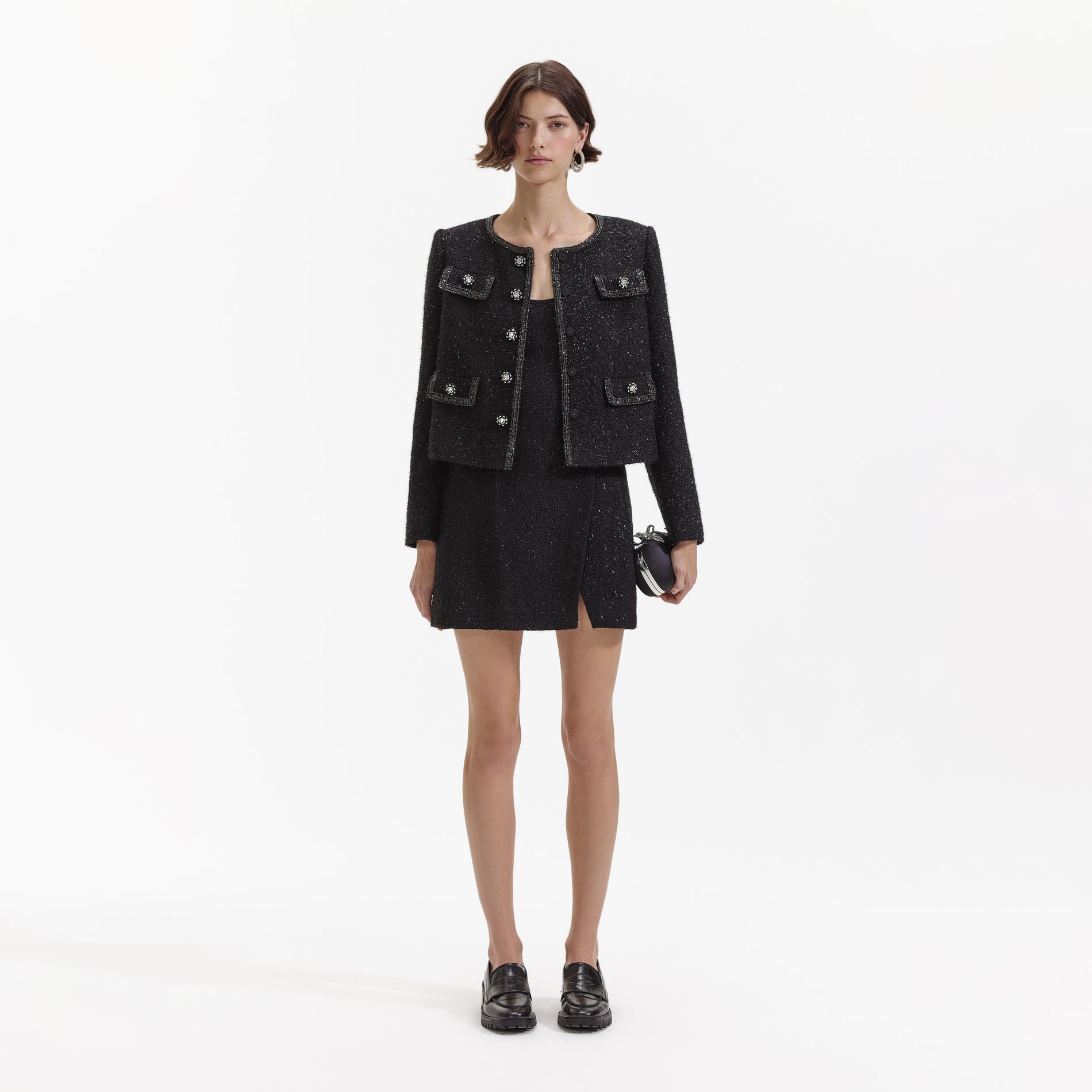 Side view of a woman wearing the Black Boucle Trimmed Jacket