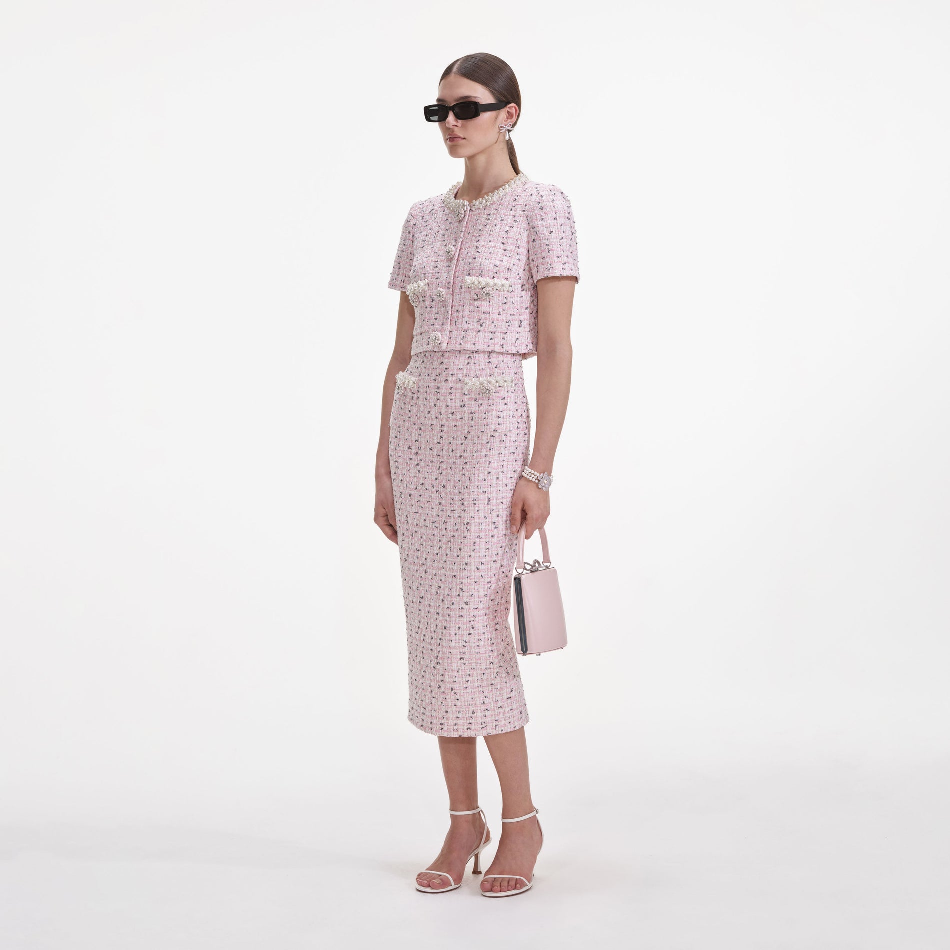Side view of a woman wearing the Pink Boucle Pearl Top