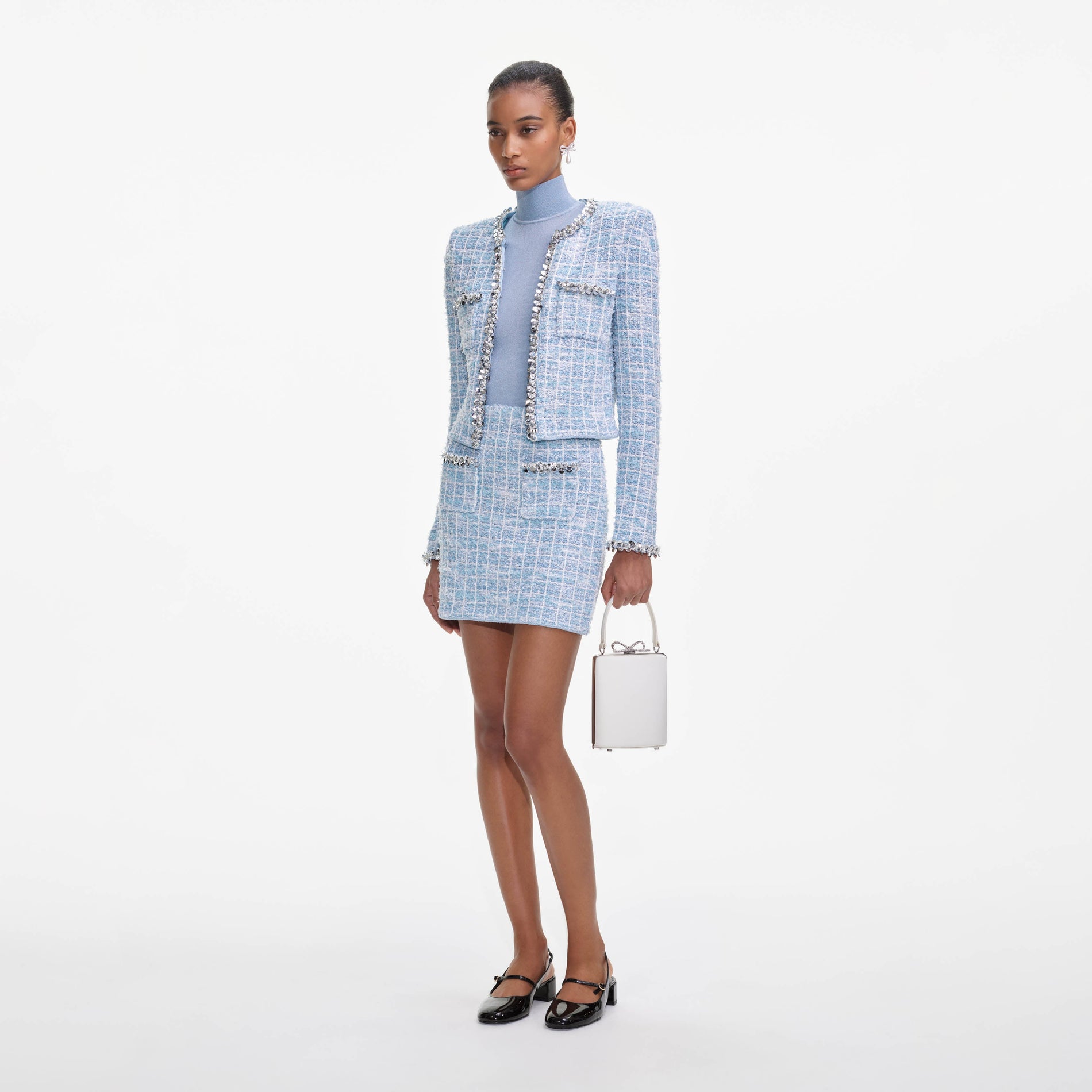 Side view of a woman wearing the Blue Check Knit Mini Skirt