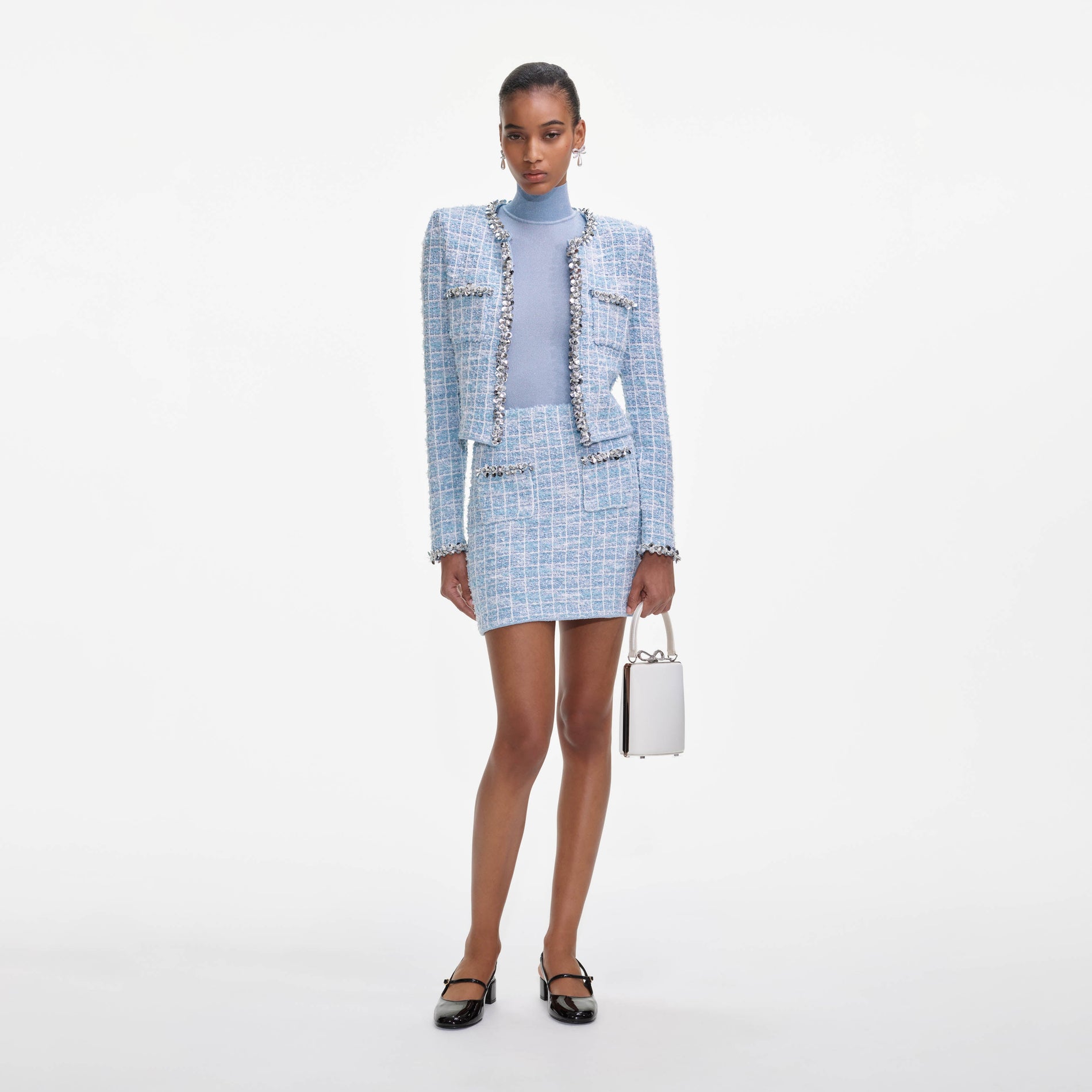 A close up of a woman wearing the Blue Check Cardigan