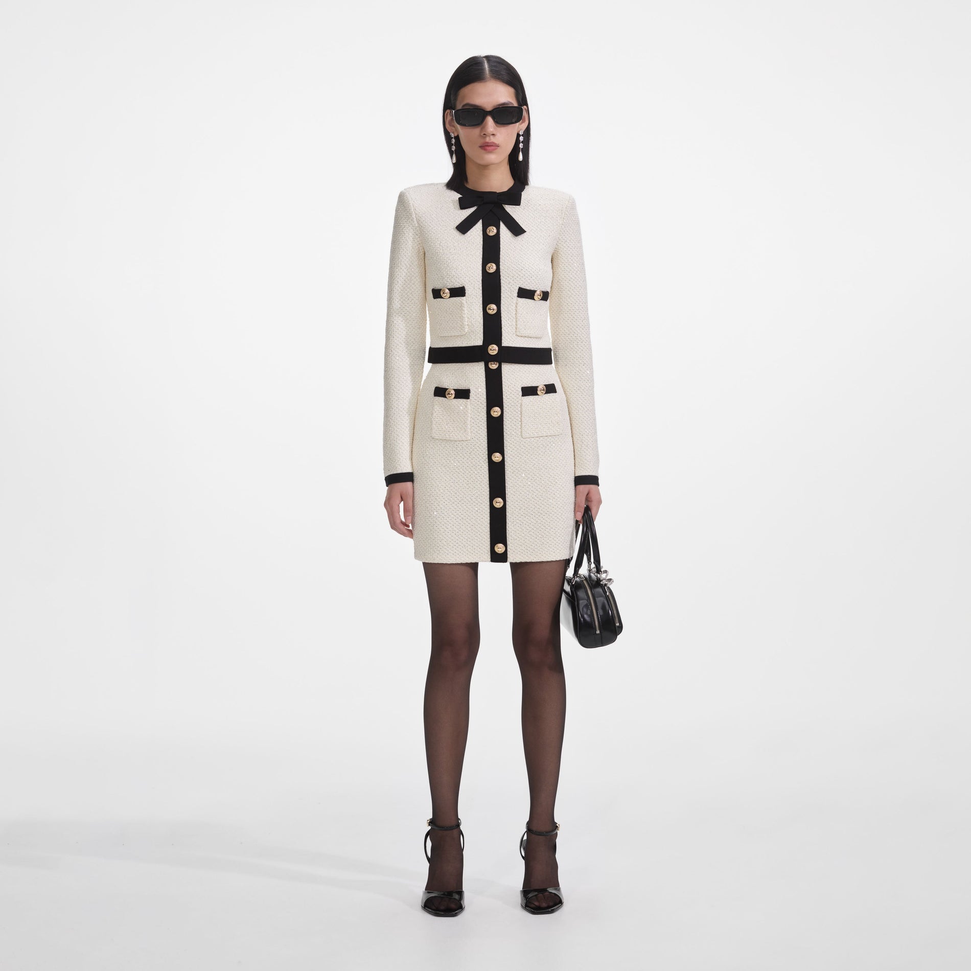 Front view of a woman wearing the Cream Sequin Knit Mini Skirt