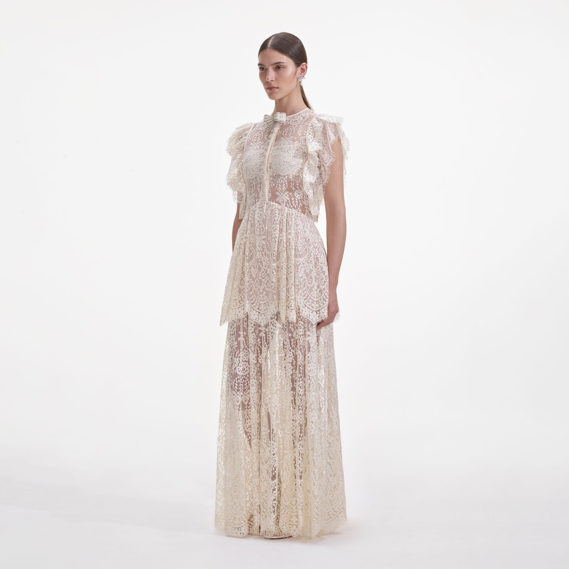 Side view of a woman wearing the White Tiered Lace Maxi Dress