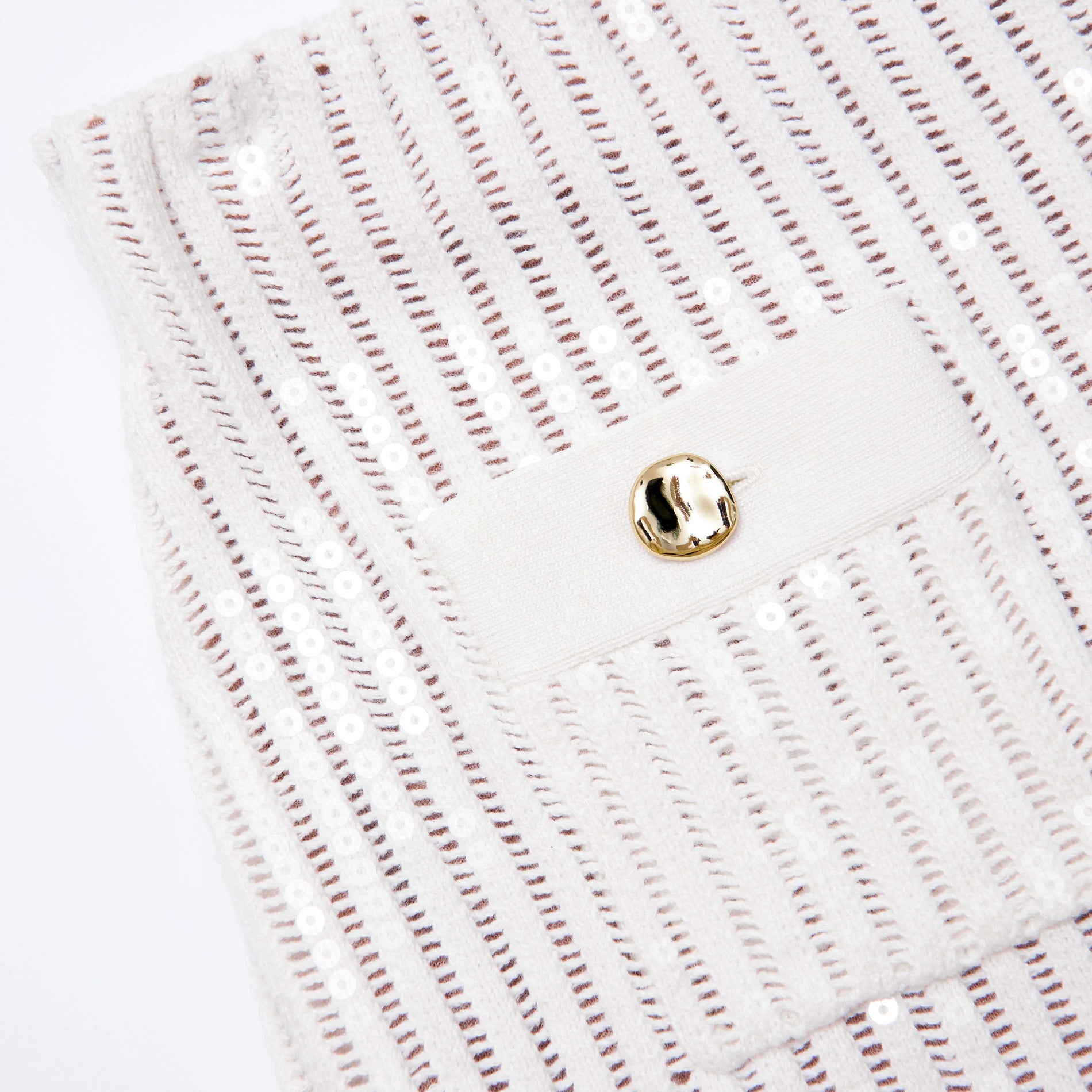 Side view of a woman wearing the White Sequin Crochet Mini Skirt