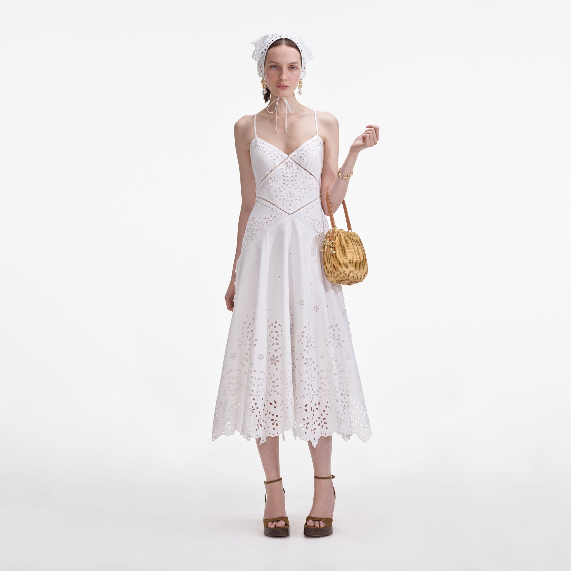 Front view of a woman wearing the White Cotton Embroidered Midi Dress