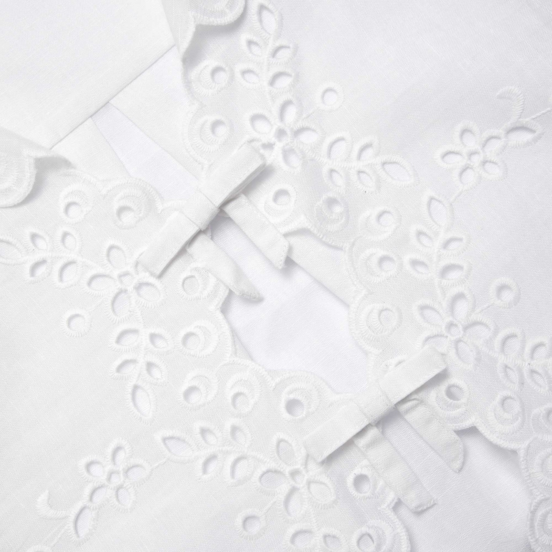 Side view of a woman wearing the Cream Linen Embroidered Shirt