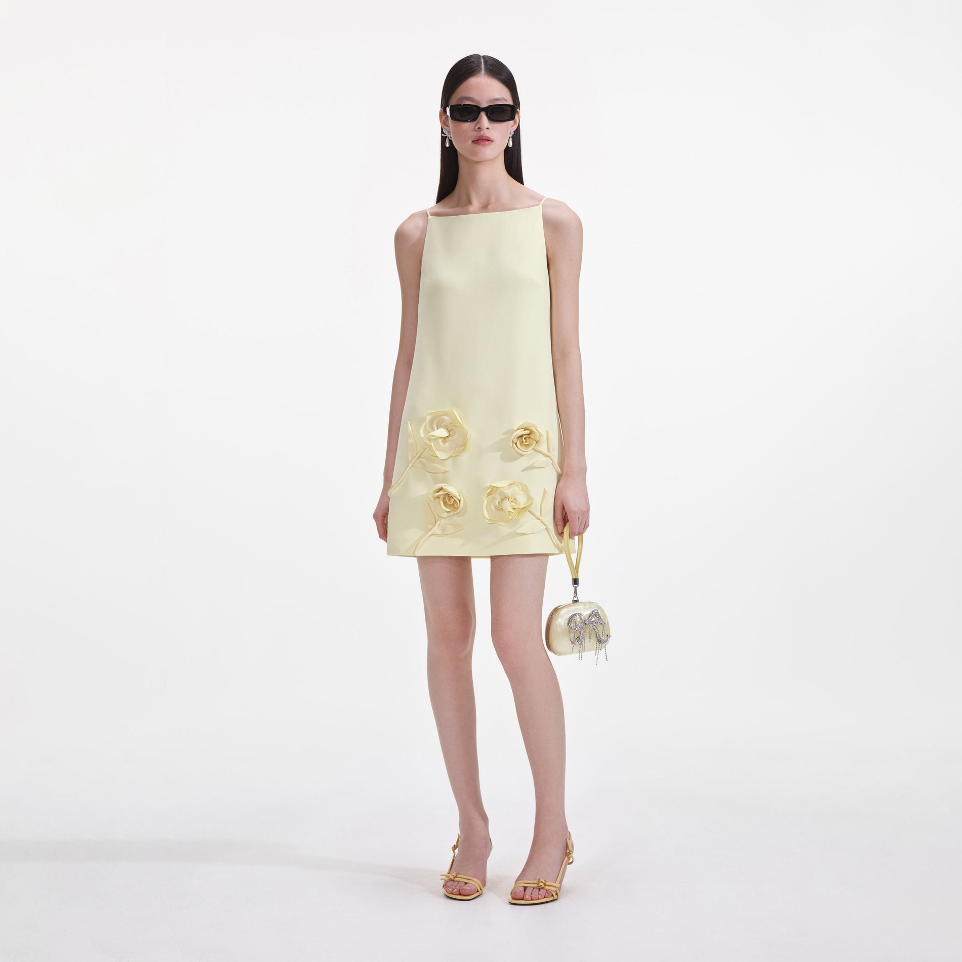 Front view of a woman wearing the Yellow Crepe Flower Mini Dress