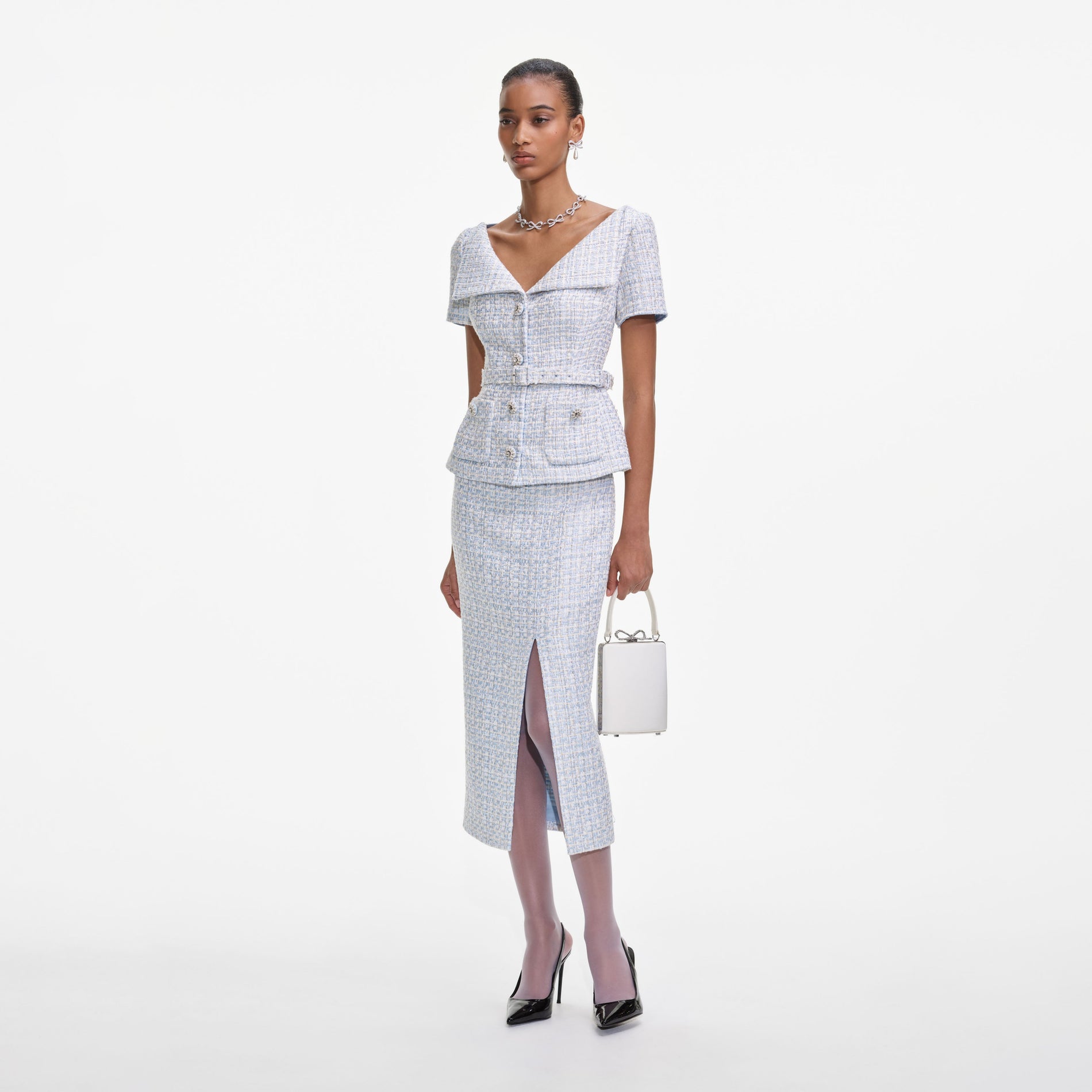 Side view of a woman wearing the Blue Boucle Midi Dress