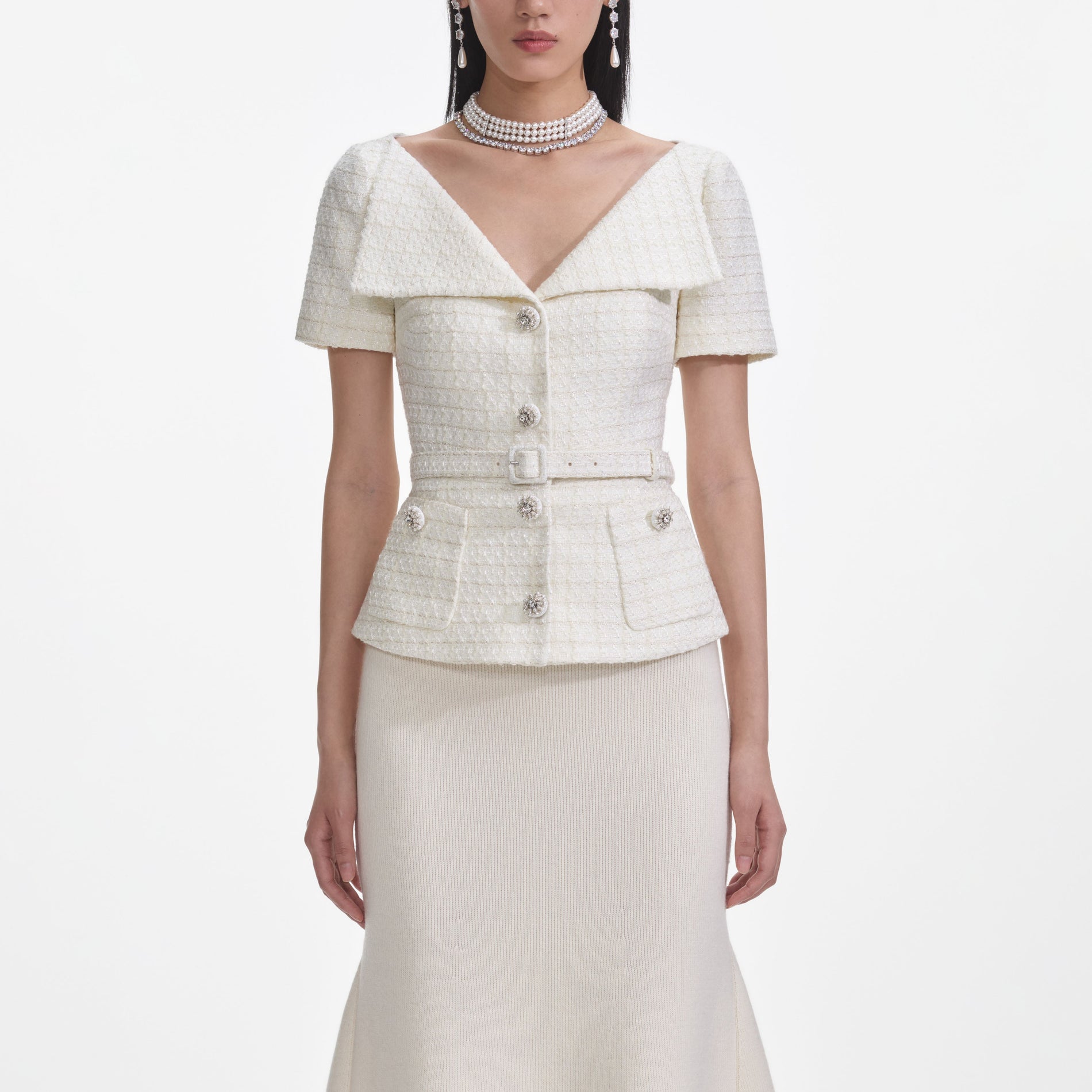 A close up of a woman wearing the Cream Boucle Top