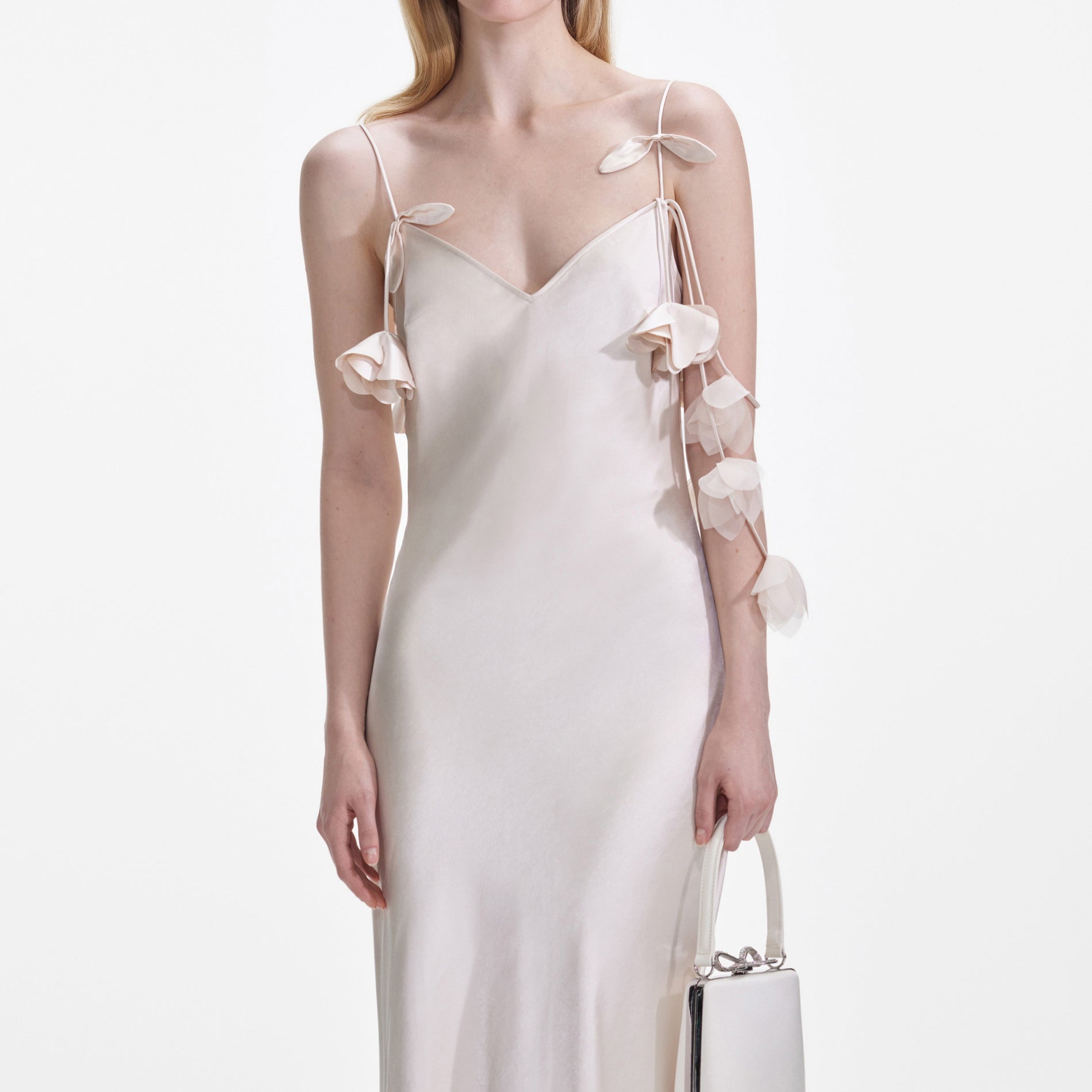 A close up of a woman wearing the Champagne Flower Satin Maxi Dress