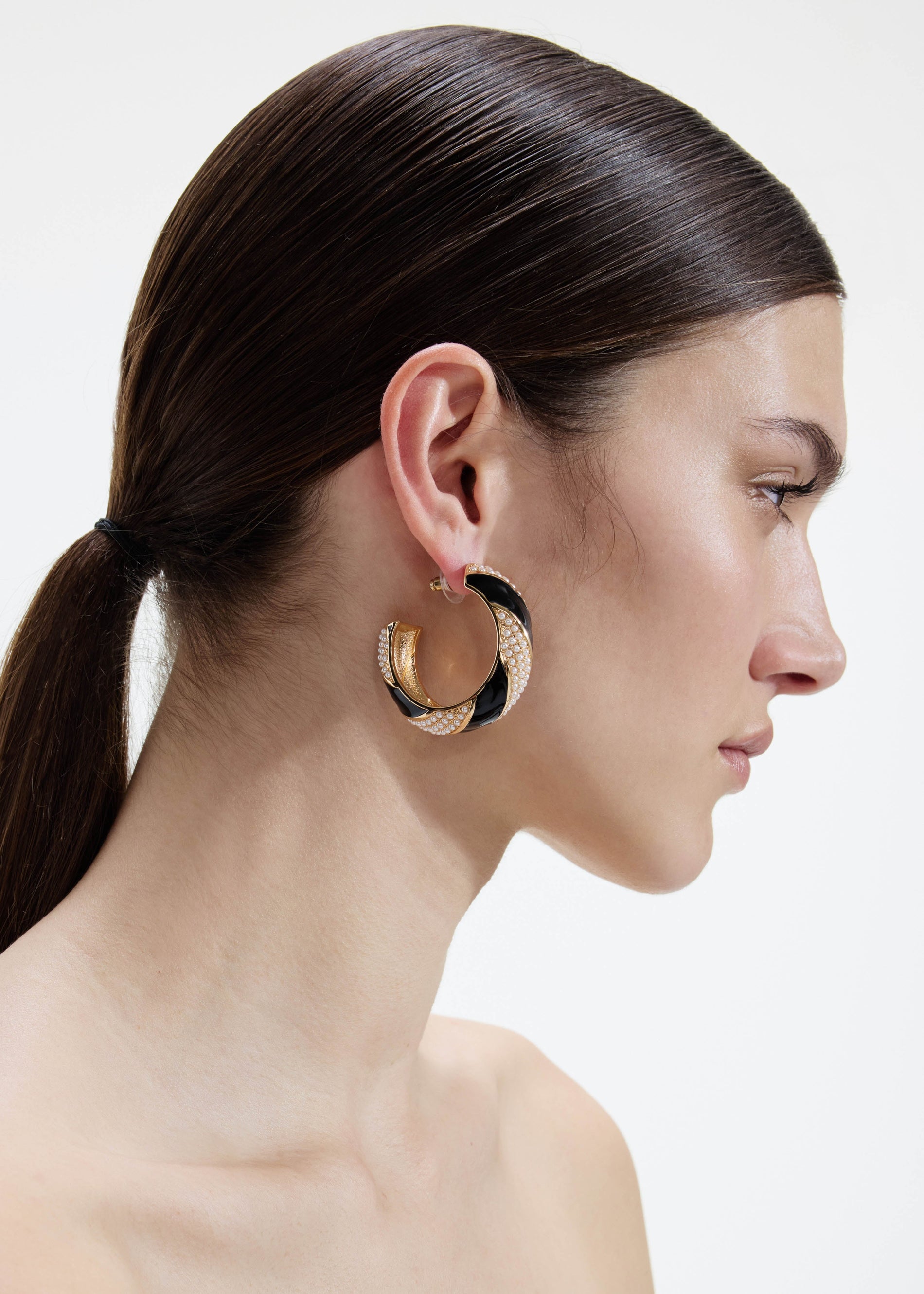 A photo of the Black And Gold Pearl Hoop Earrings