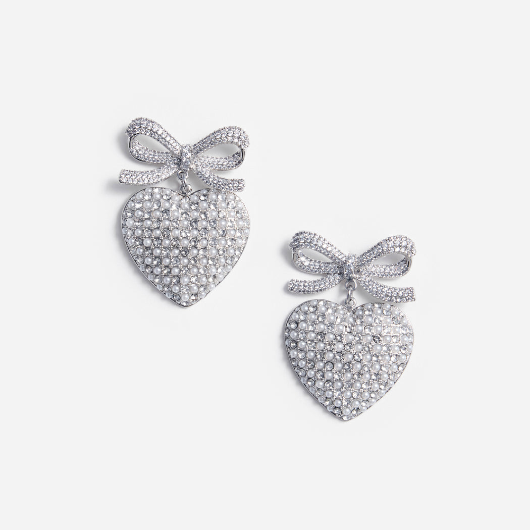 A photo of the Crystal Bow Pearl Heart Earrings