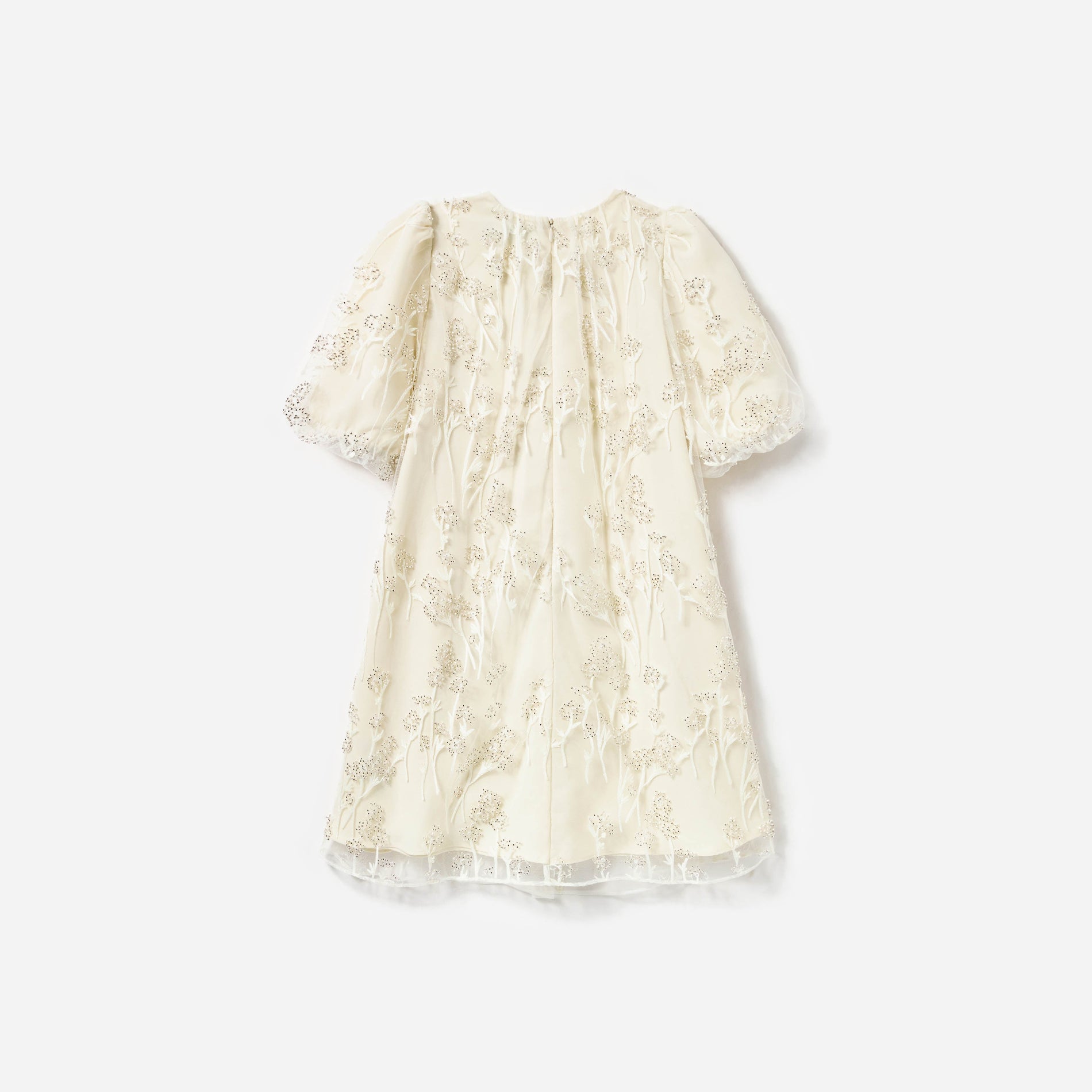 Side view of a woman wearing the Cream Tulle Flower Dress