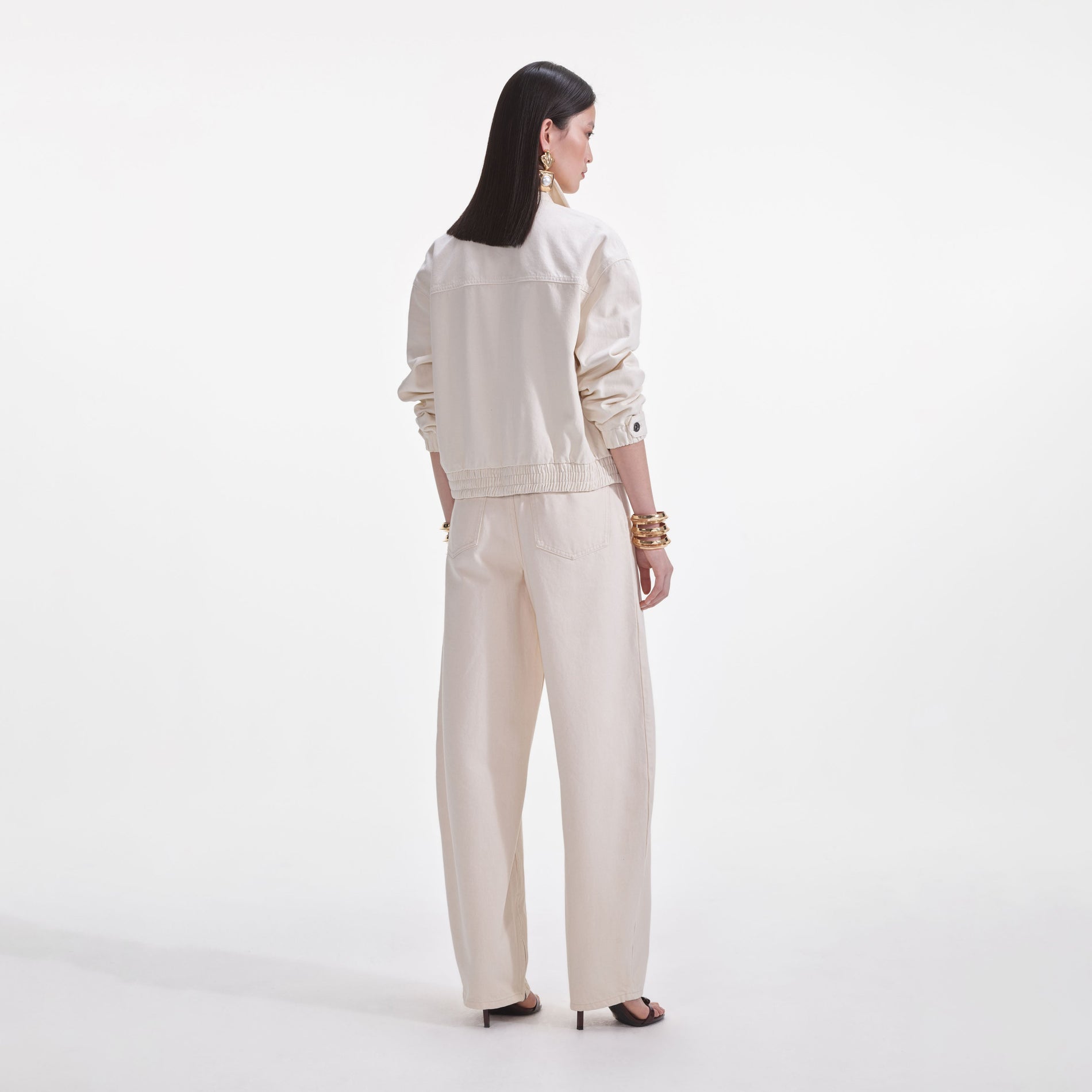 Back view of a woman wearing the Cream Lightweight Denim Jacket