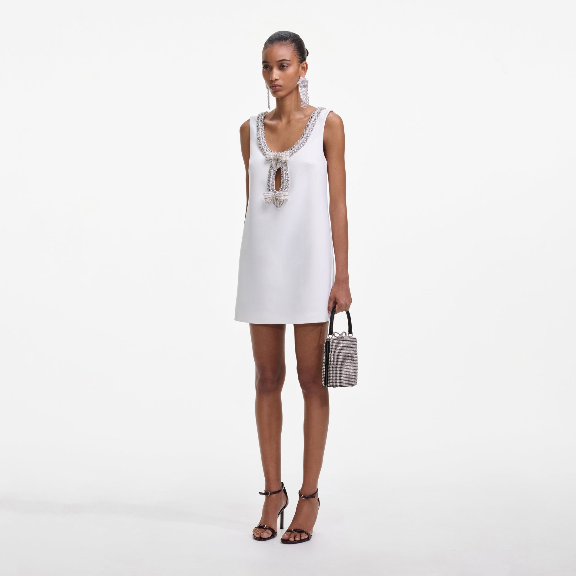 Side view of a woman wearing the White Bonded Crepe Mini Dress