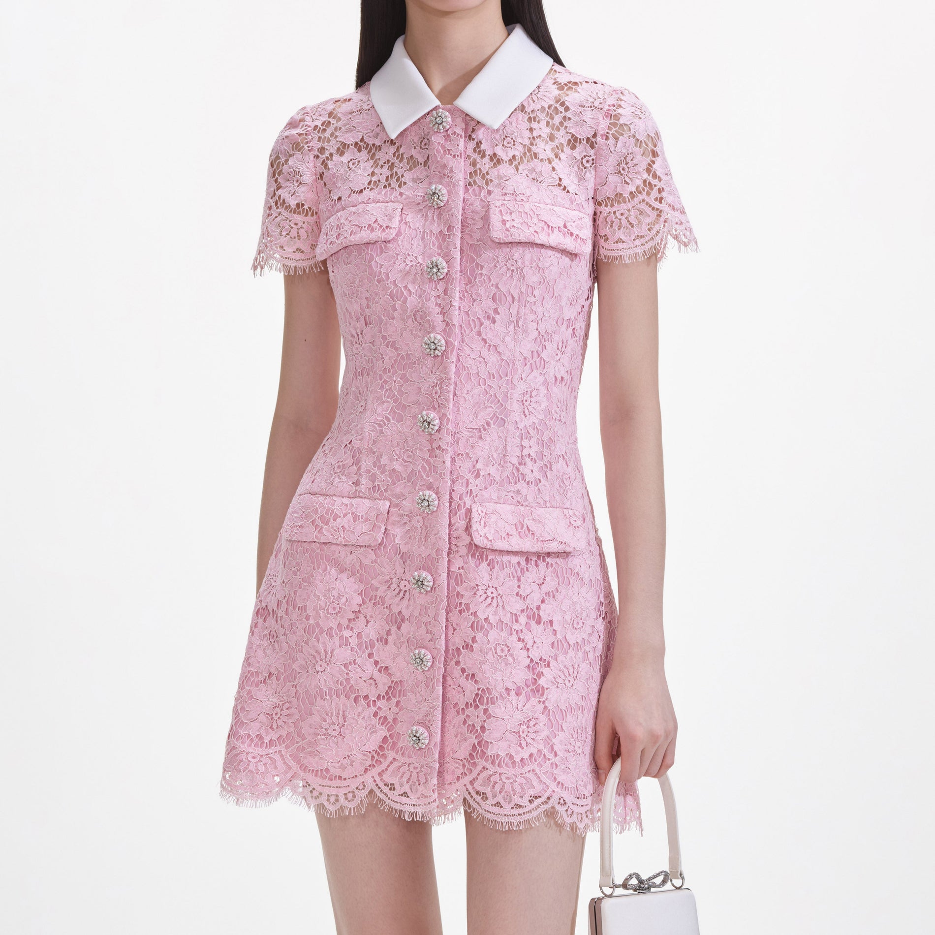 A close up of a woman wearing the Pink Lace Collared Mini Dress