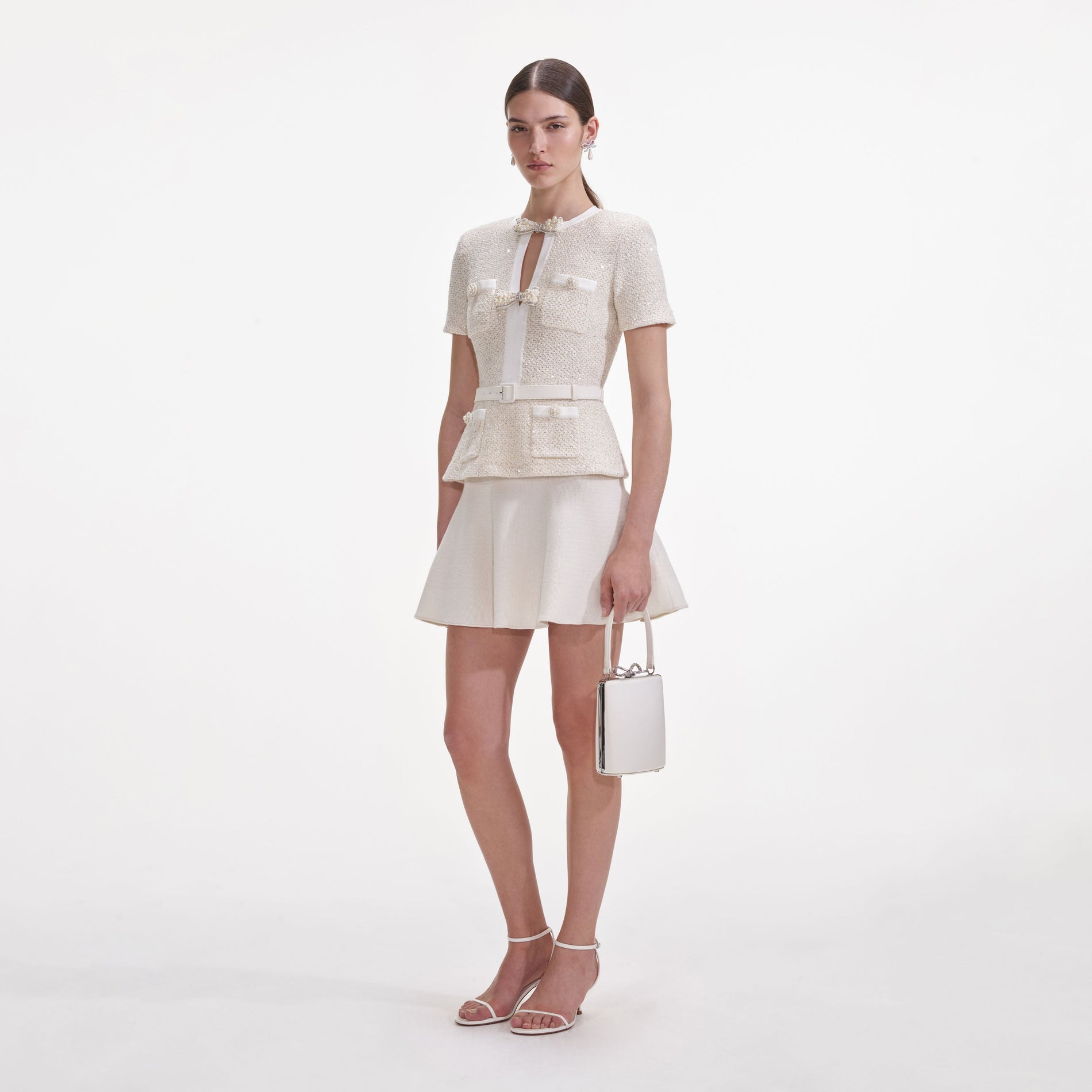 Side view of a woman wearing the Cream Sequin Knit Mini Dress