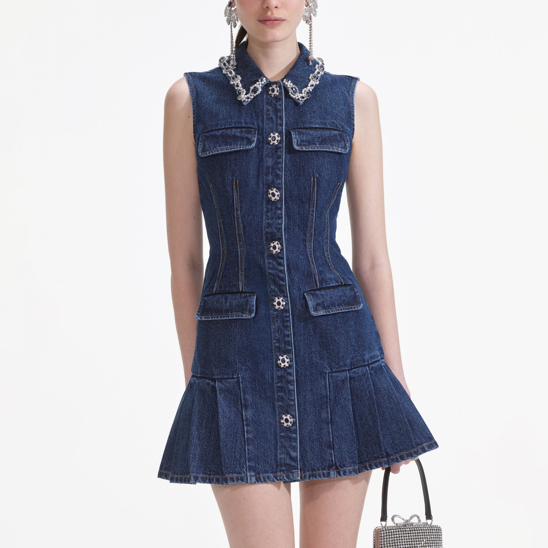 A close up of a woman wearing the Denim Sleeveless Mini Dress