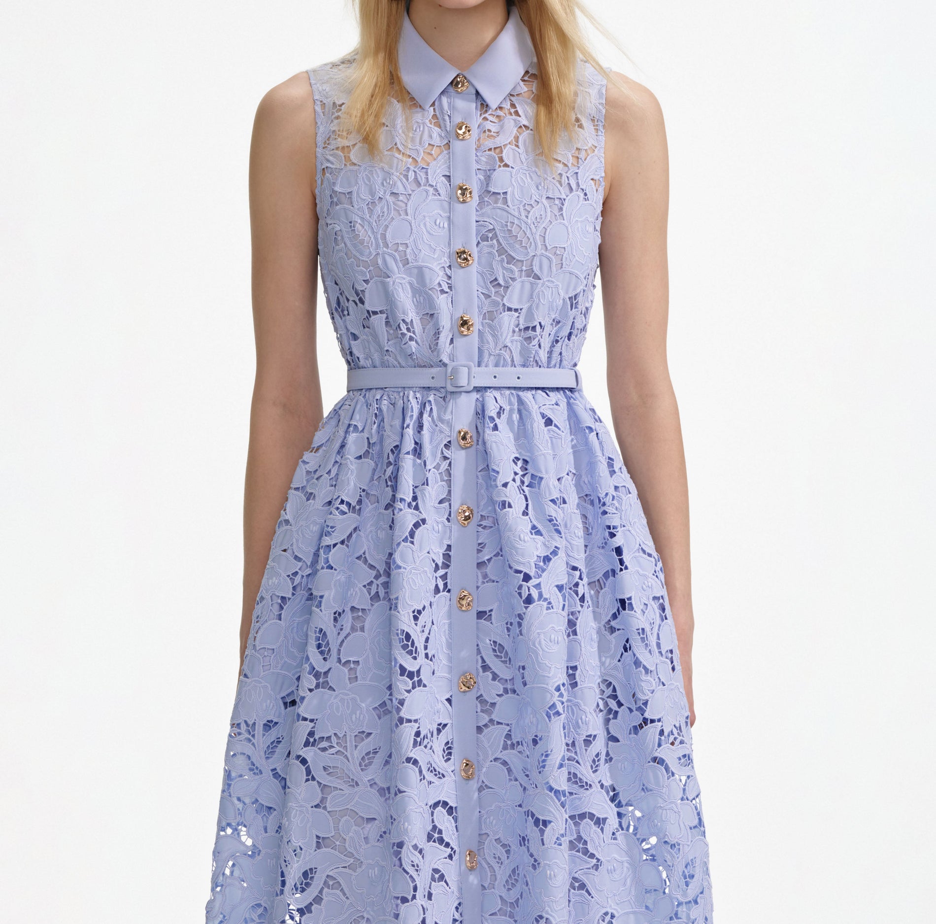 A close up of a woman wearing the Blue Lace Sleeveless Midi Dress