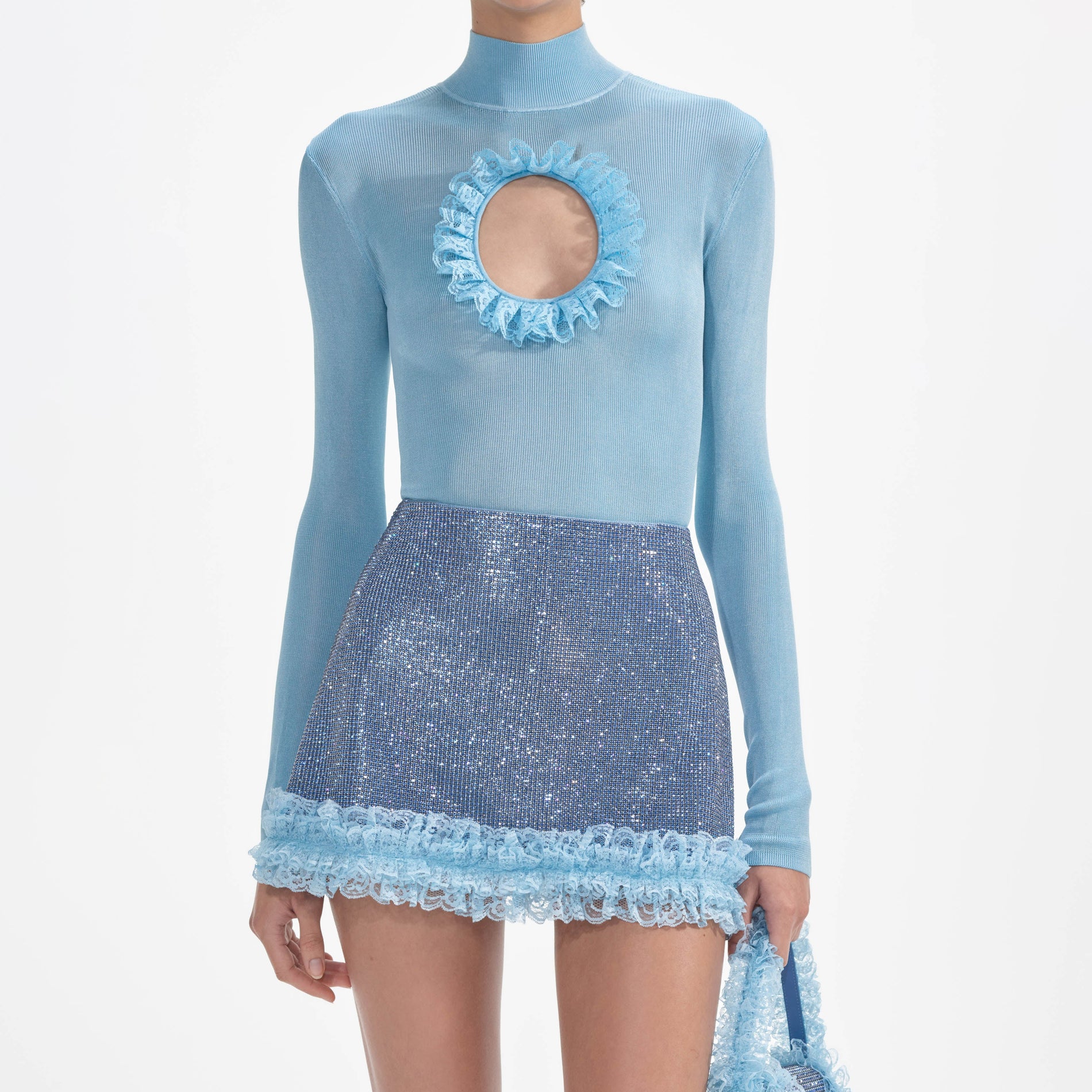 A close up of a woman wearing the Blue Knit Cut Out Bodysuit