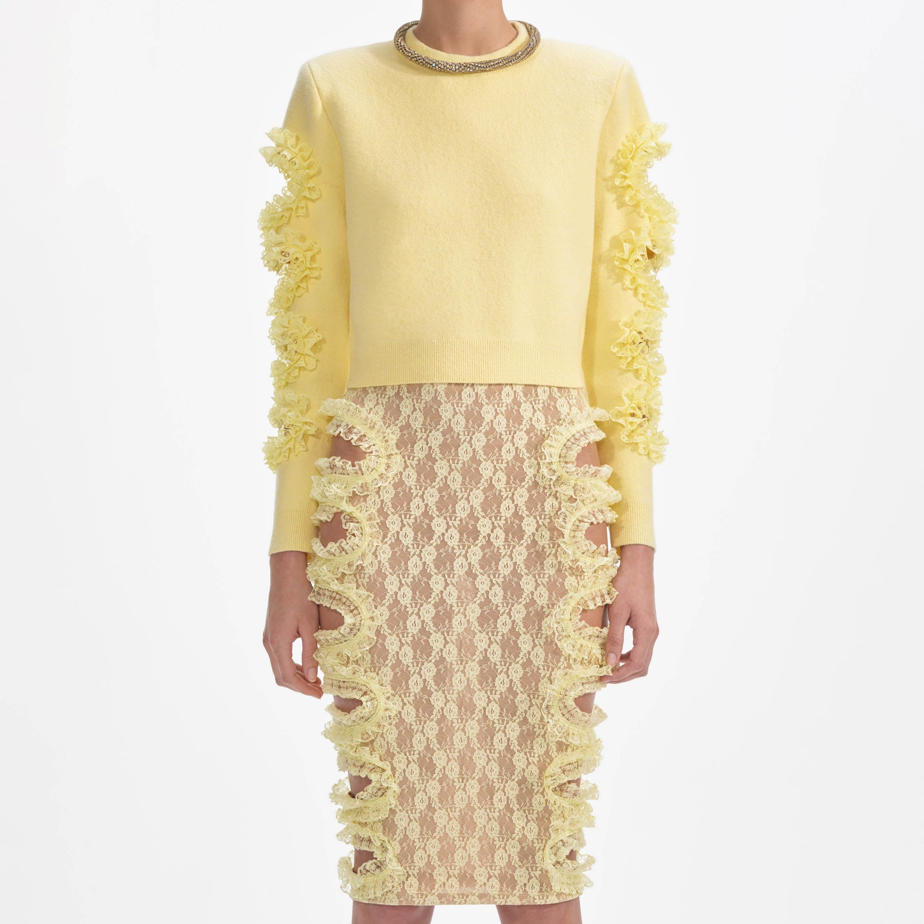 A close up of a woman wearing the Yellow Lace Cut Out Midi Skirt