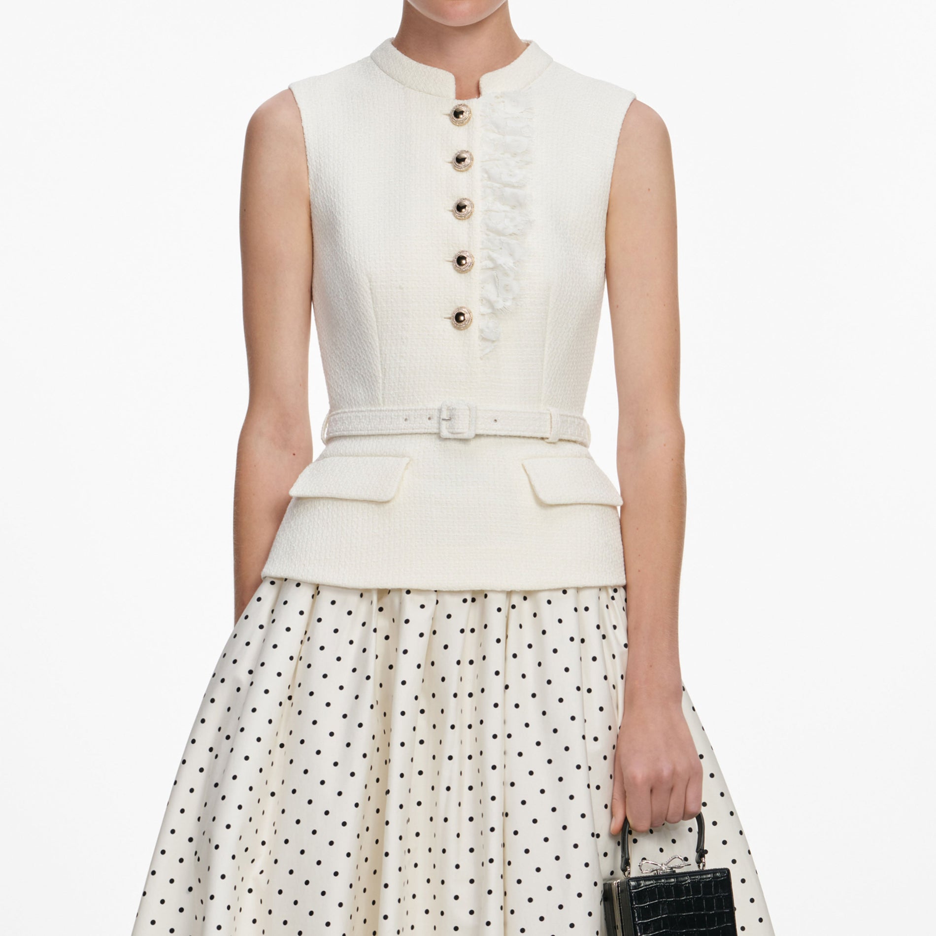 A close up of a woman wearing the Cream Boucle Polka Dot Midi Dress