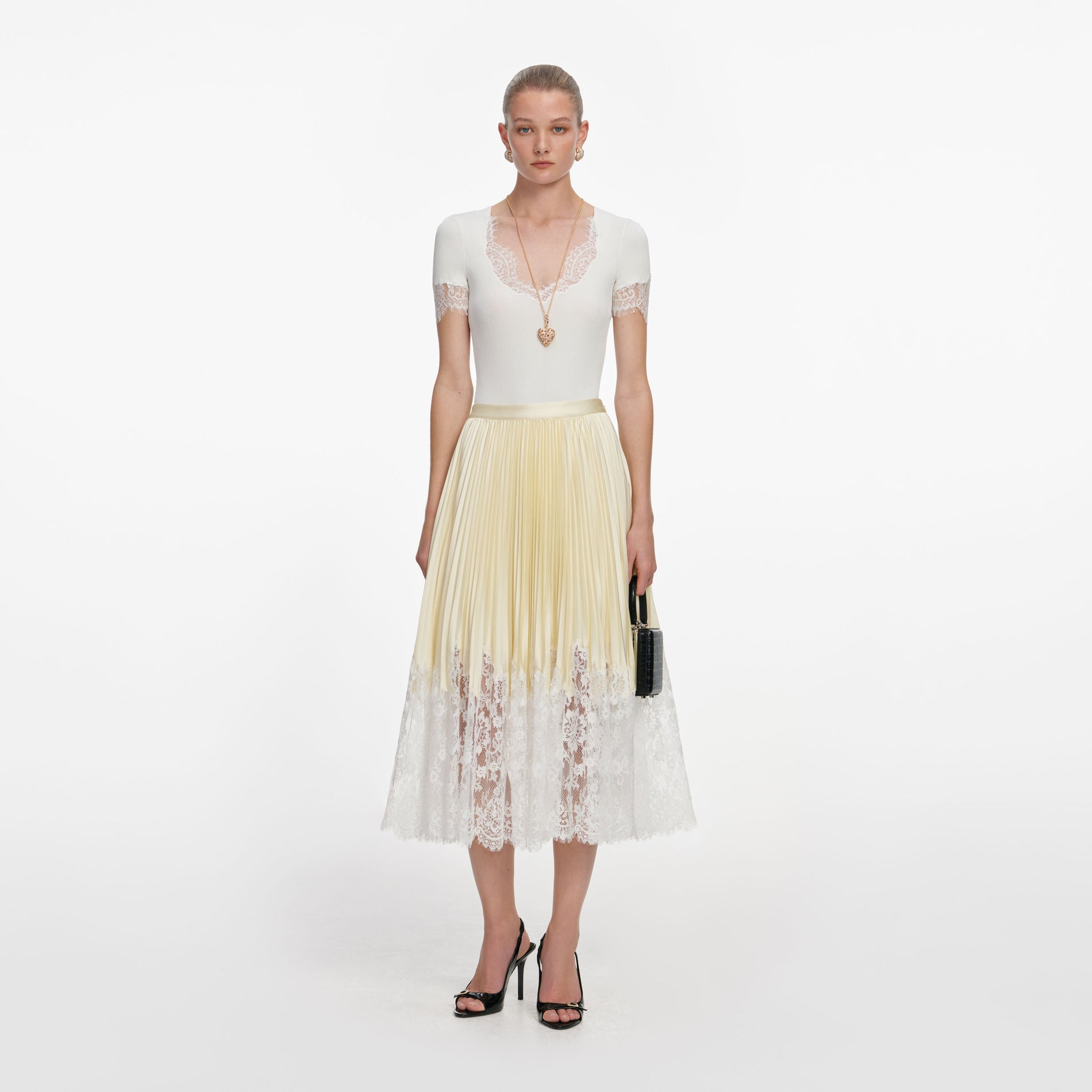Front view of a woman wearing the Yellow Satin Lace Midi Skirt