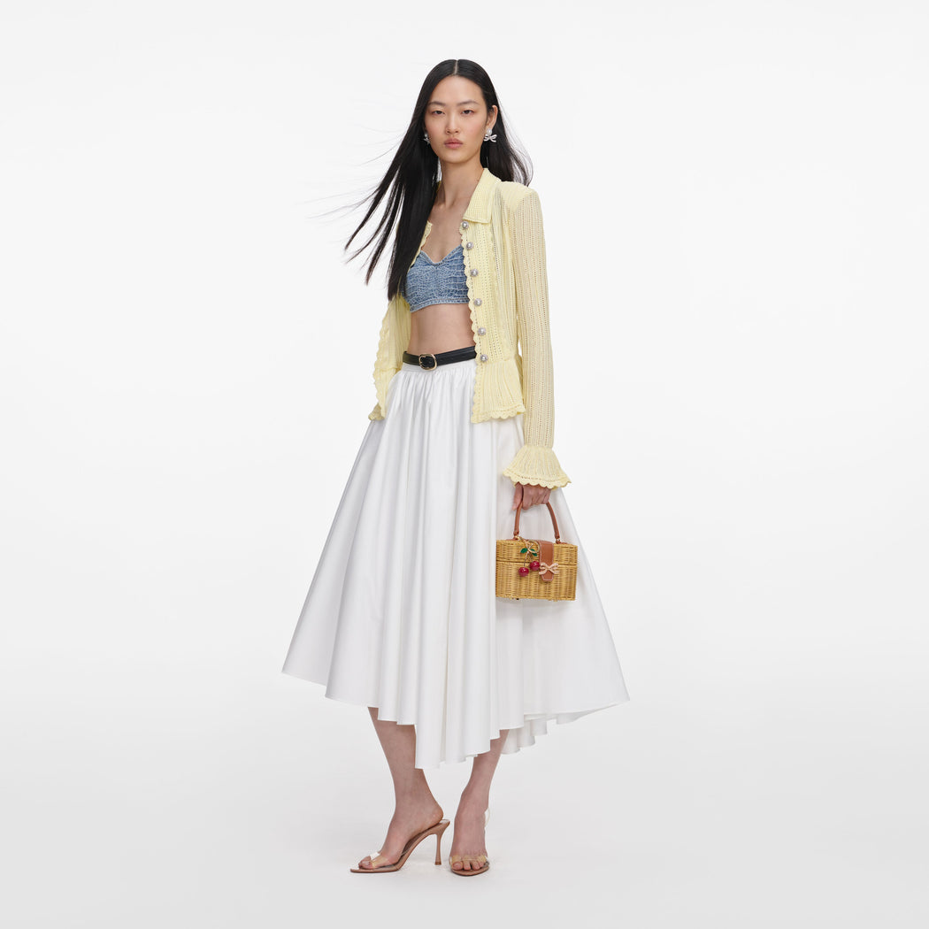 Side view of a woman wearing the Yellow Pointelle Cardigan