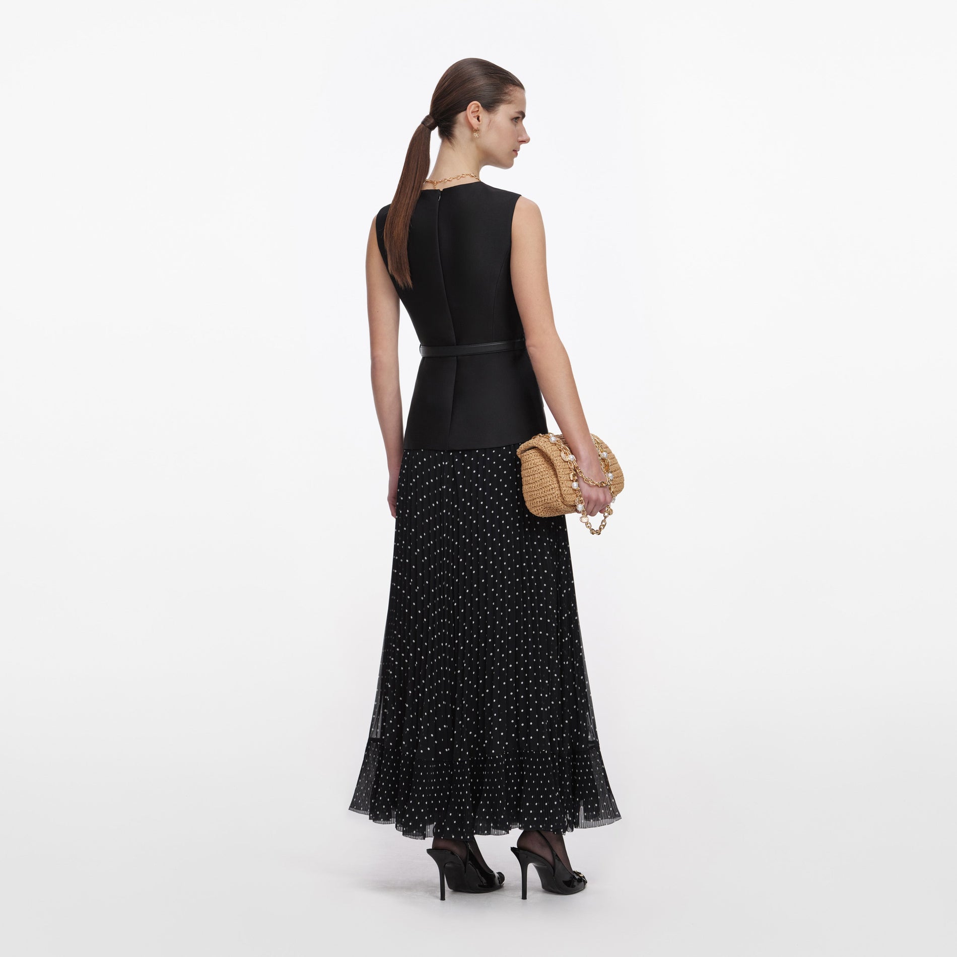 Back view of a woman wearing the Black Taffeta Polka Dot Midi Dress