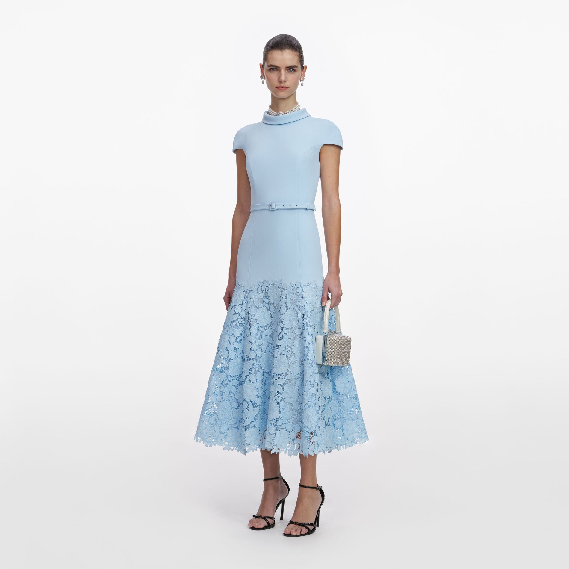 Side view of a woman wearing the Blue Crepe Lace Midi Dress