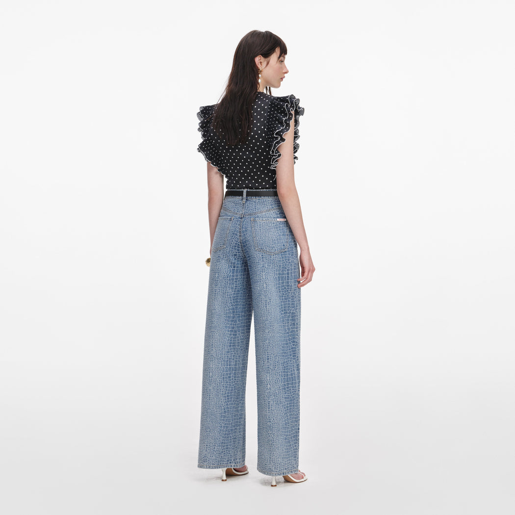 Back view of a woman wearing the Black Polka Dot Frill Top