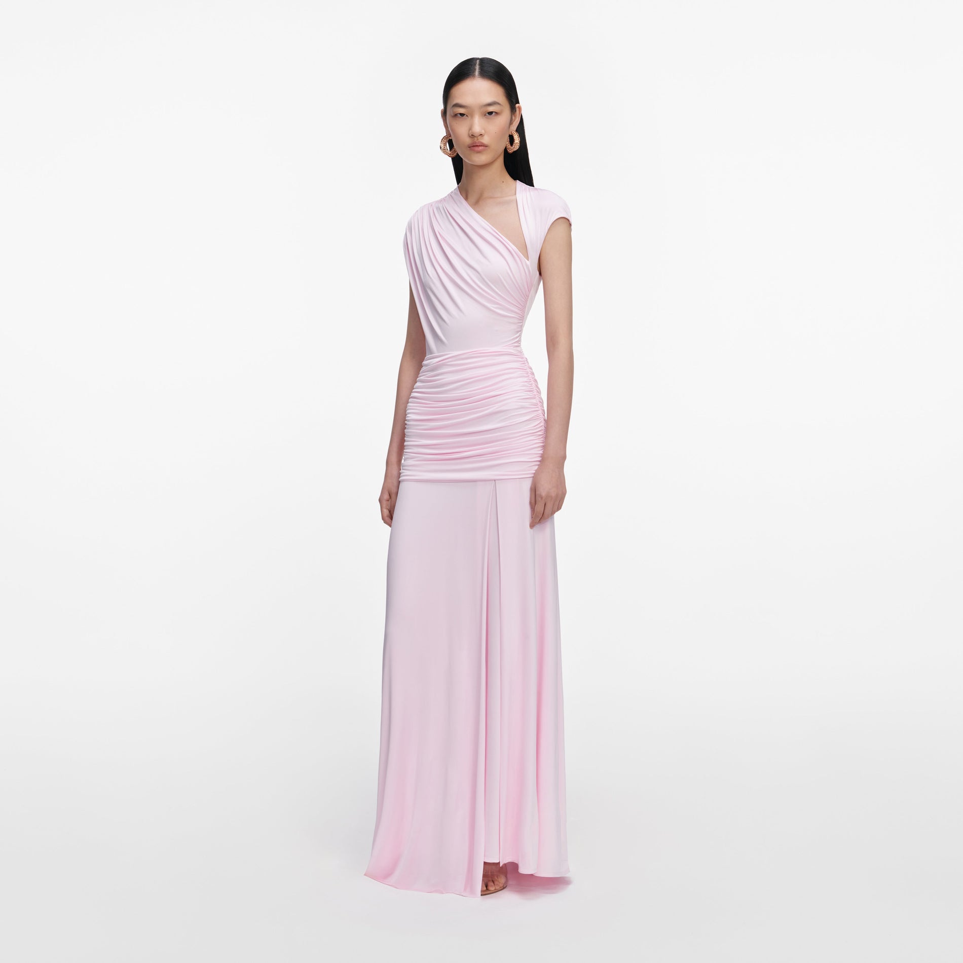 Side view of a woman wearing the Pink Jersey Draped Maxi Dress