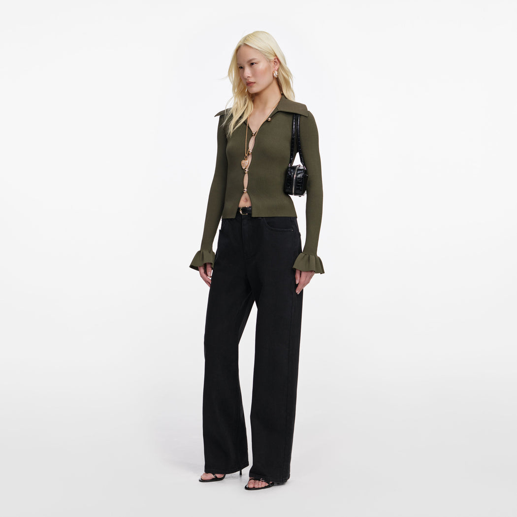 Side view of a woman wearing the Khaki Button Down Knit Top