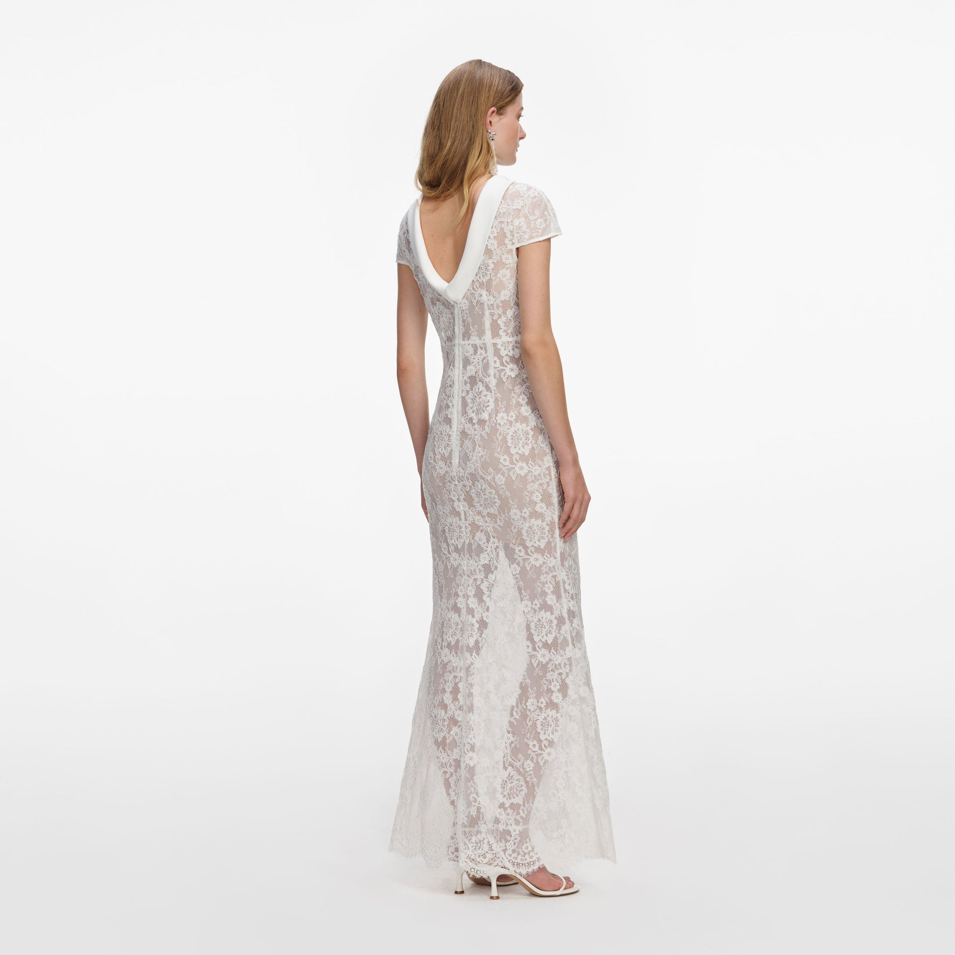 Back view of a woman wearing the White Lace Scoop Back Maxi Dress