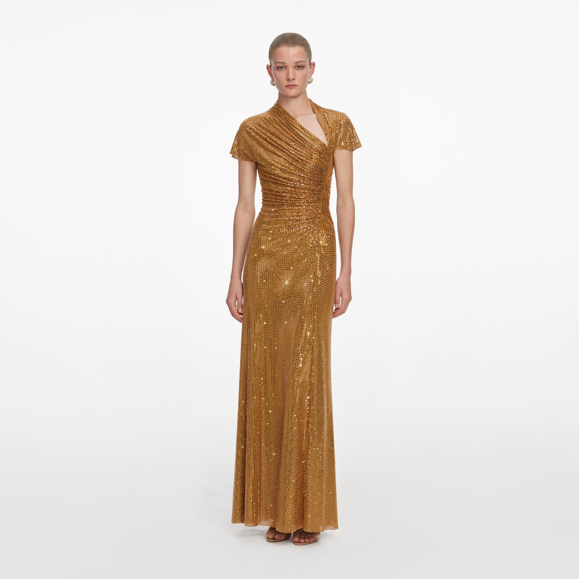 Front view of a woman wearing the Gold Rhinestone Drape Maxi Dress