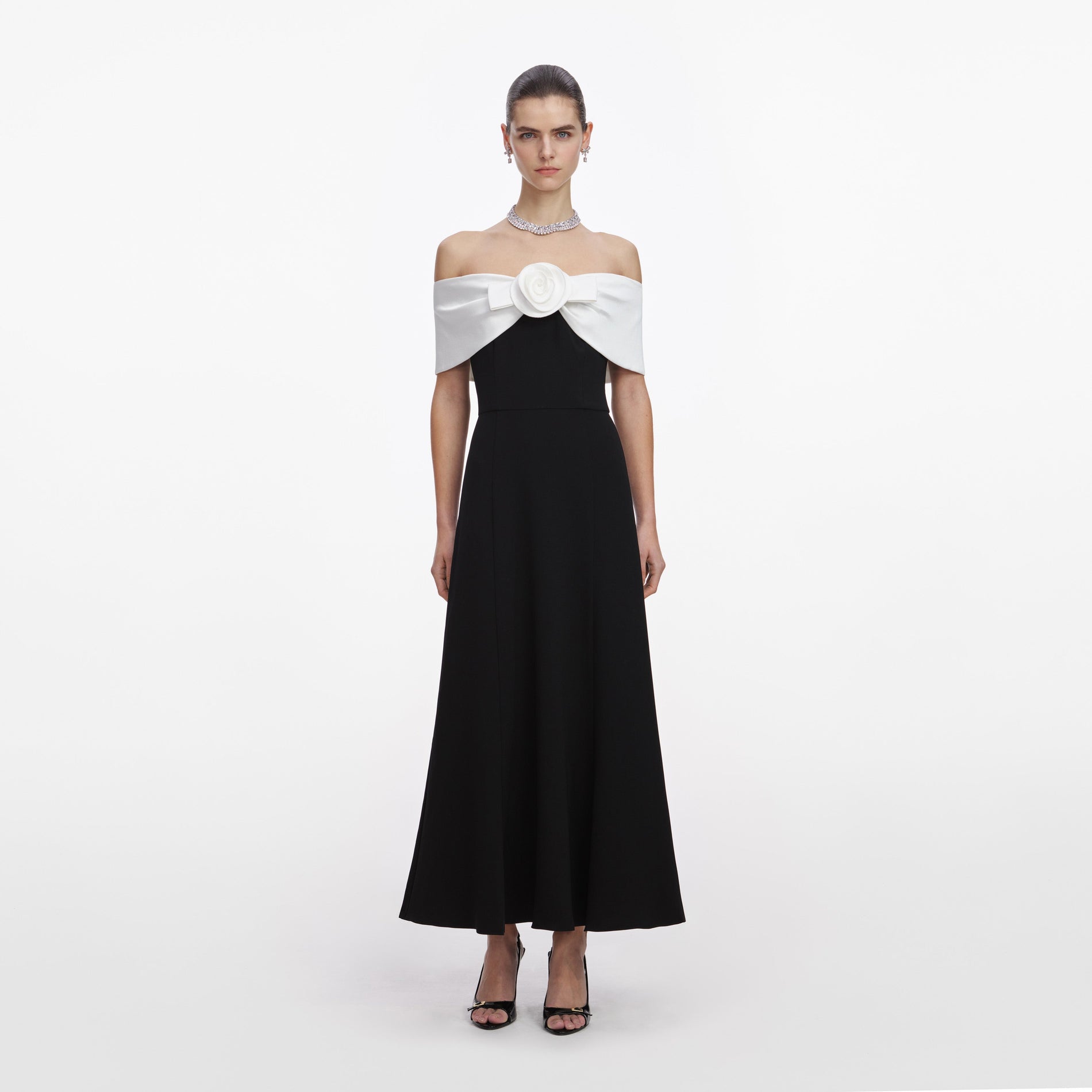 Front view of a woman wearing the Black Crepe Flower Midi Dress