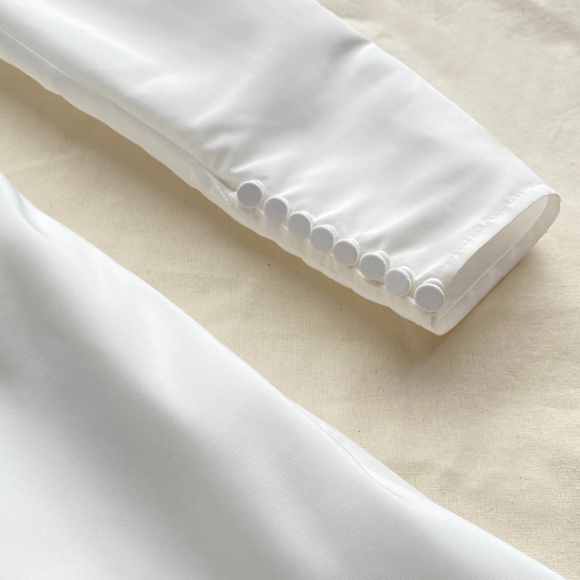 A close up of the fabric for the White Taffeta Mini Dress