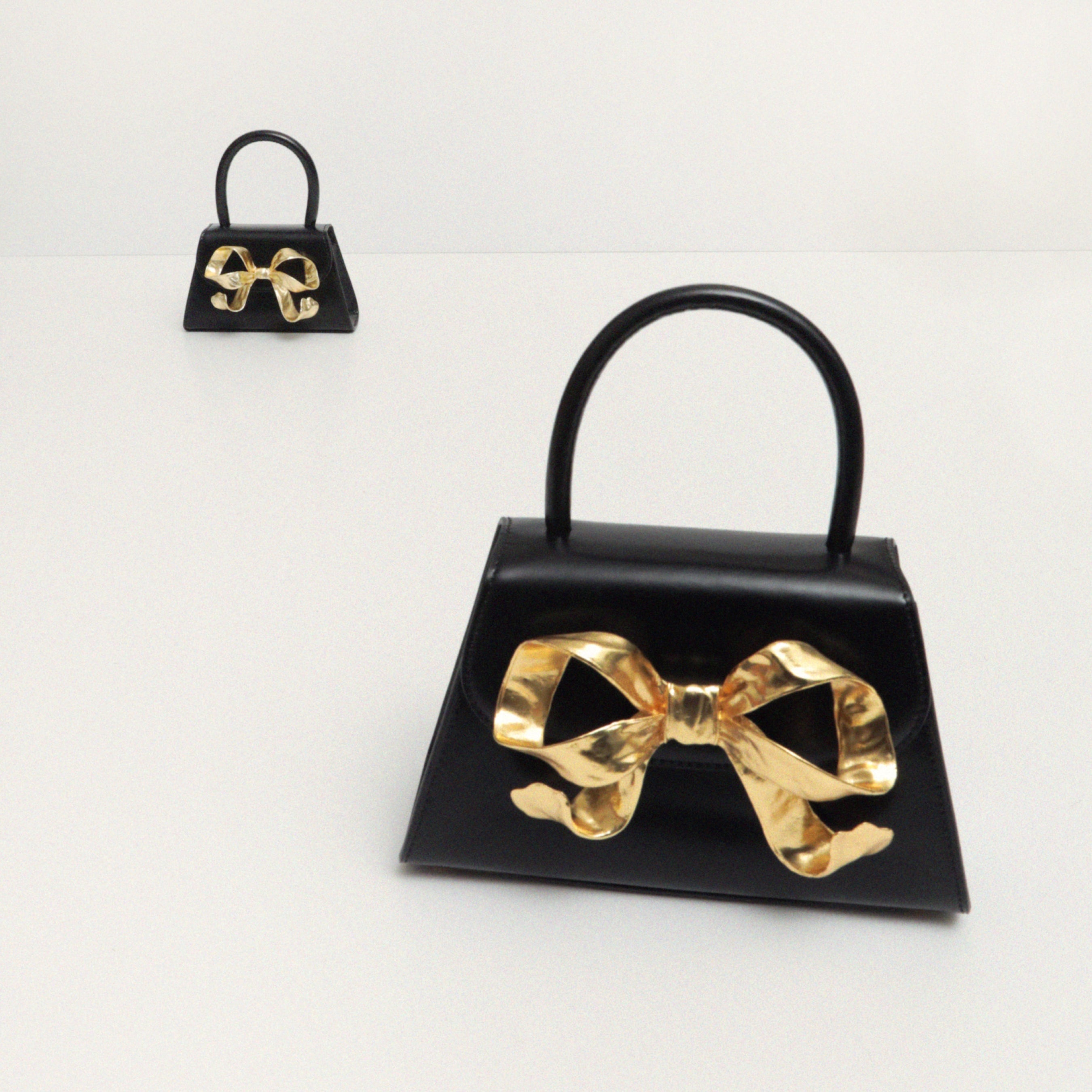 The Bow Micro in Black with Gold Hardware