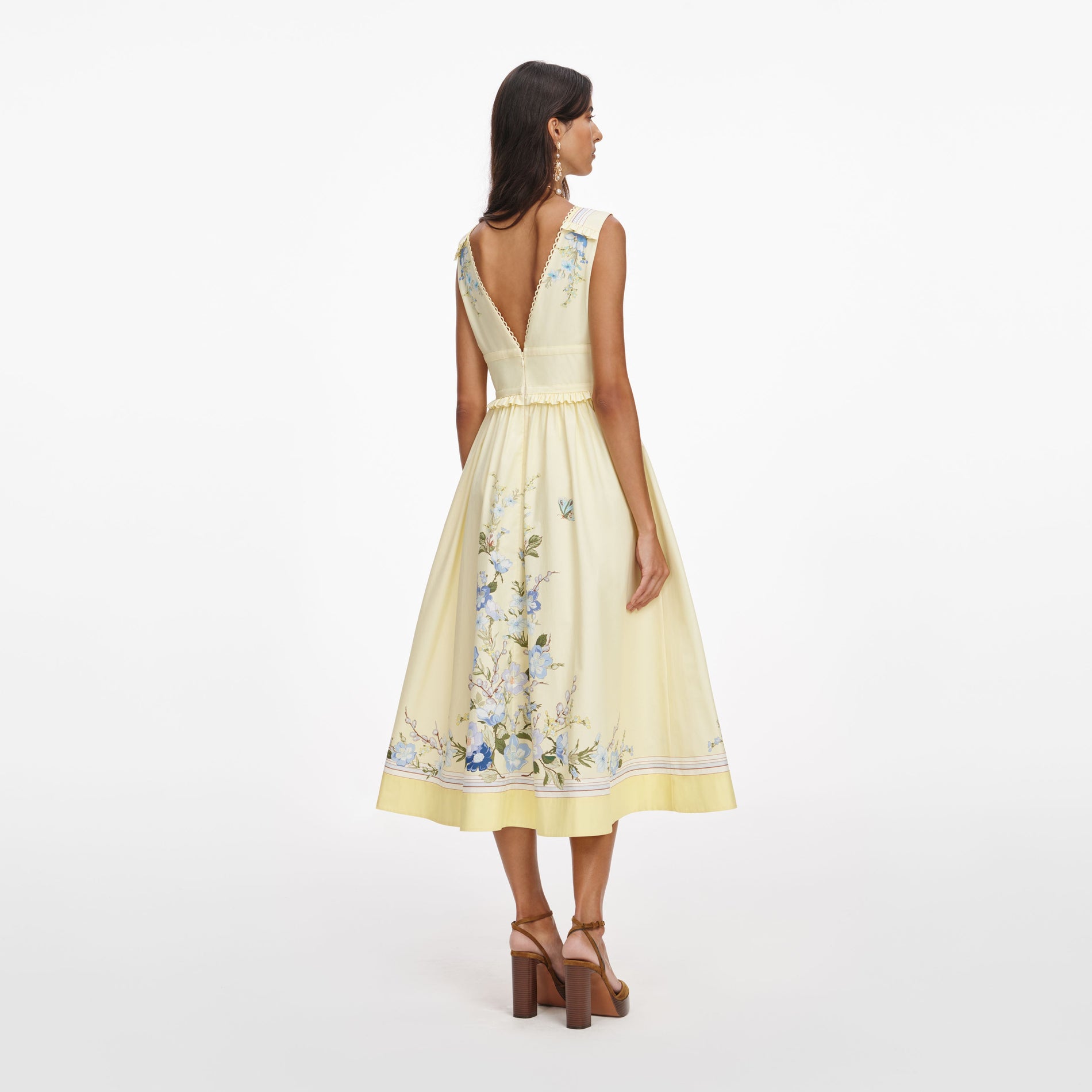 Back view of a woman wearing the Yellow Floral Cotton Midi Dress