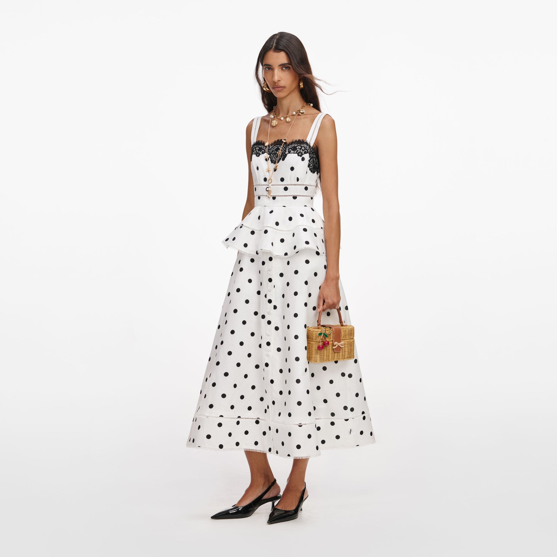 Side view of a woman wearing the White Polka Dot Linen Midi Dress