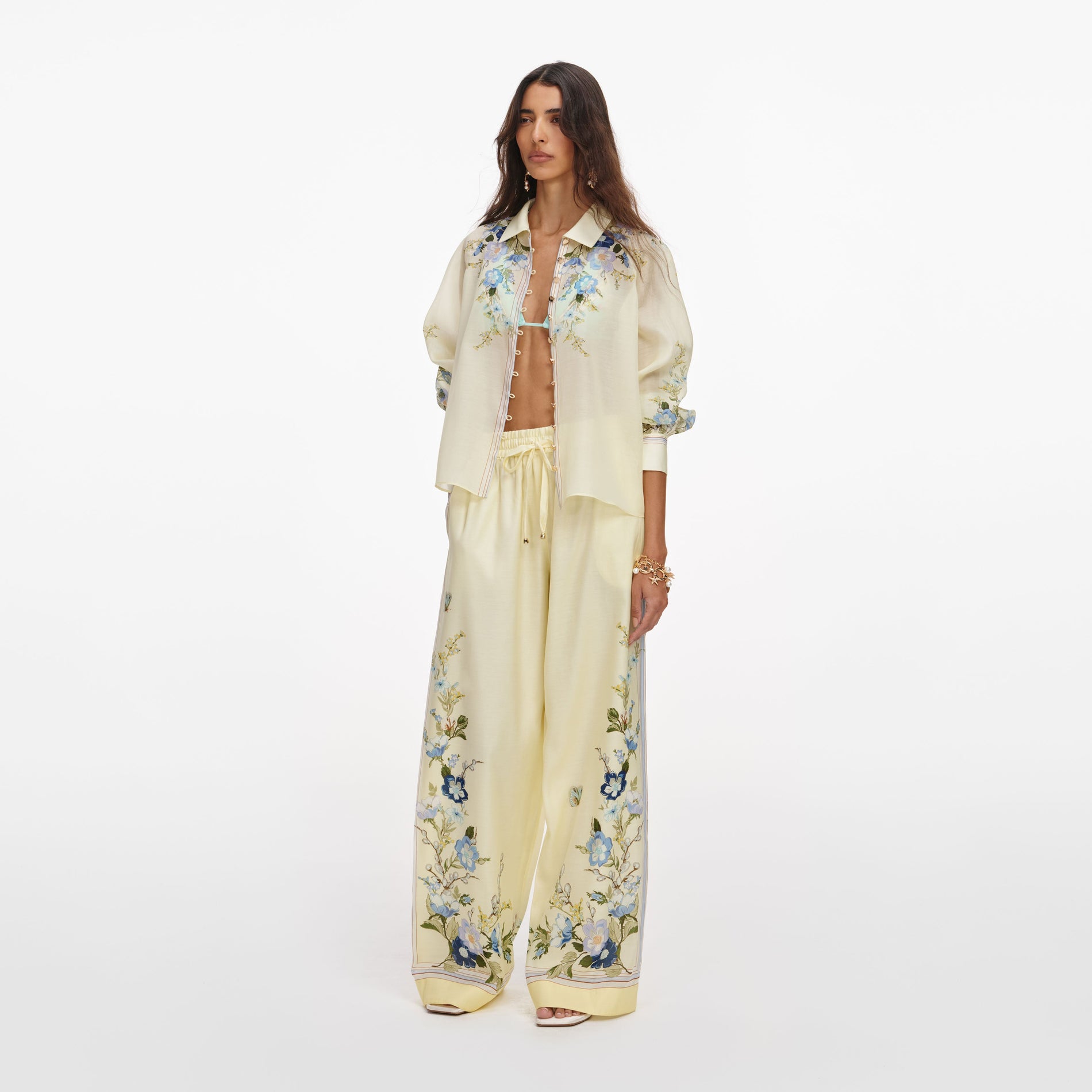 Side view of a woman wearing the Yellow Floral Organza Trousers