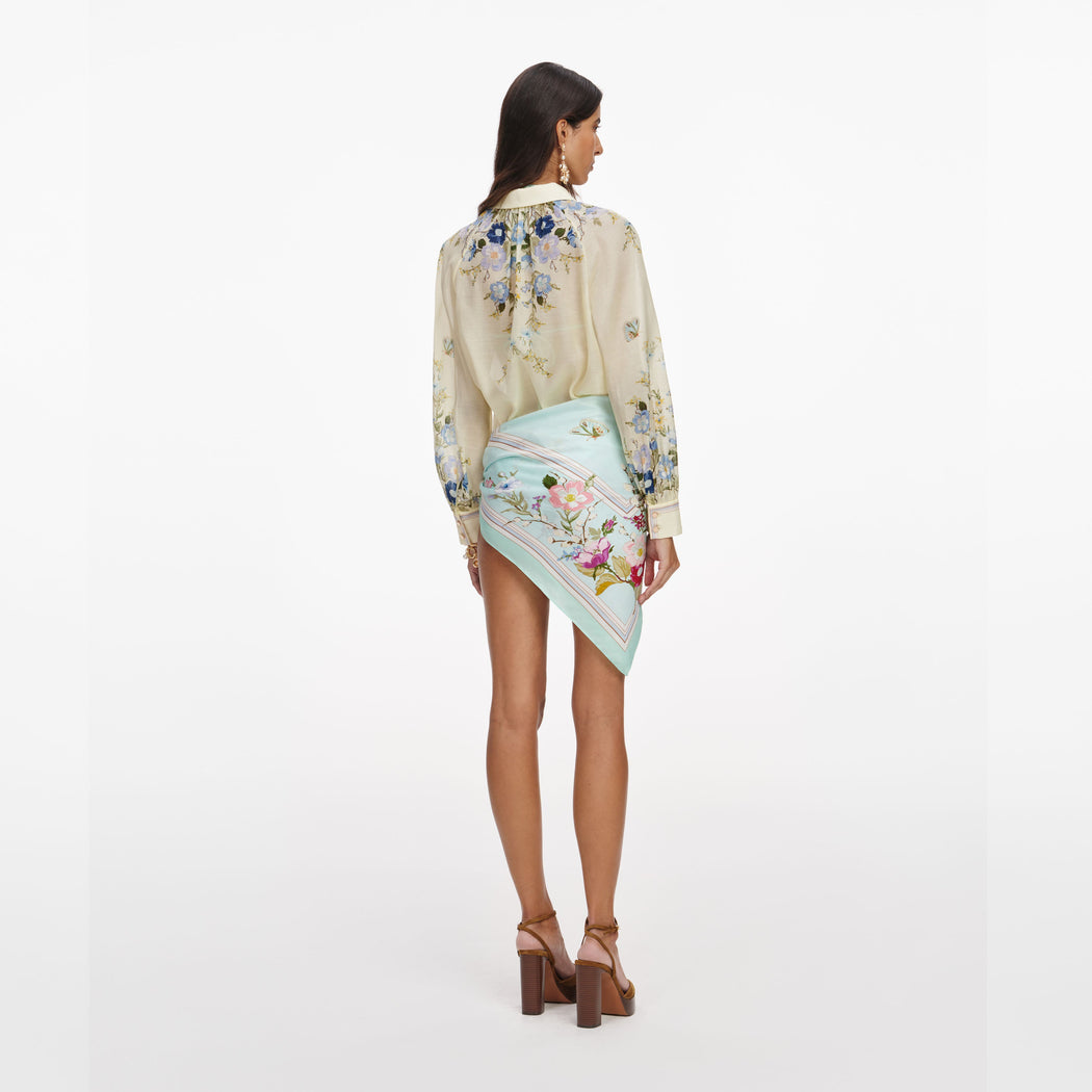 Back view of a woman wearing the Yellow Floral Organza Blouse