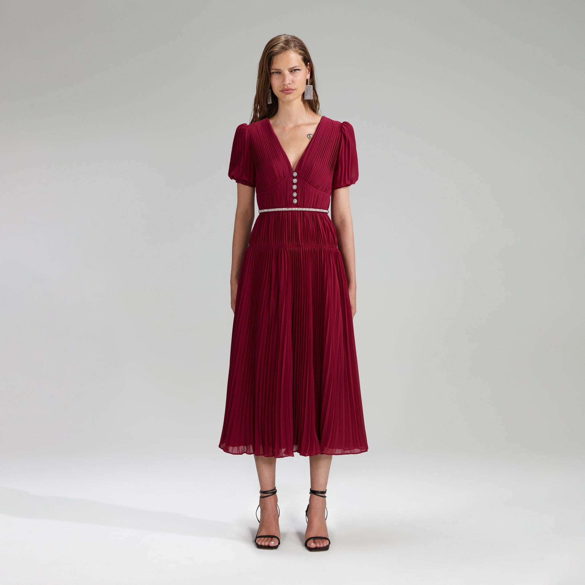 A woman wearing the Burgundy Chiffon Pleated Midi Dress