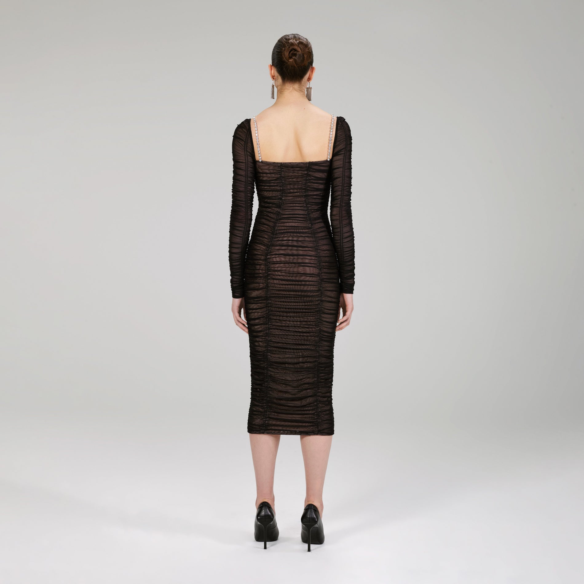 A woman wearing the Black Power Mesh Long Sleeve Midi Dress