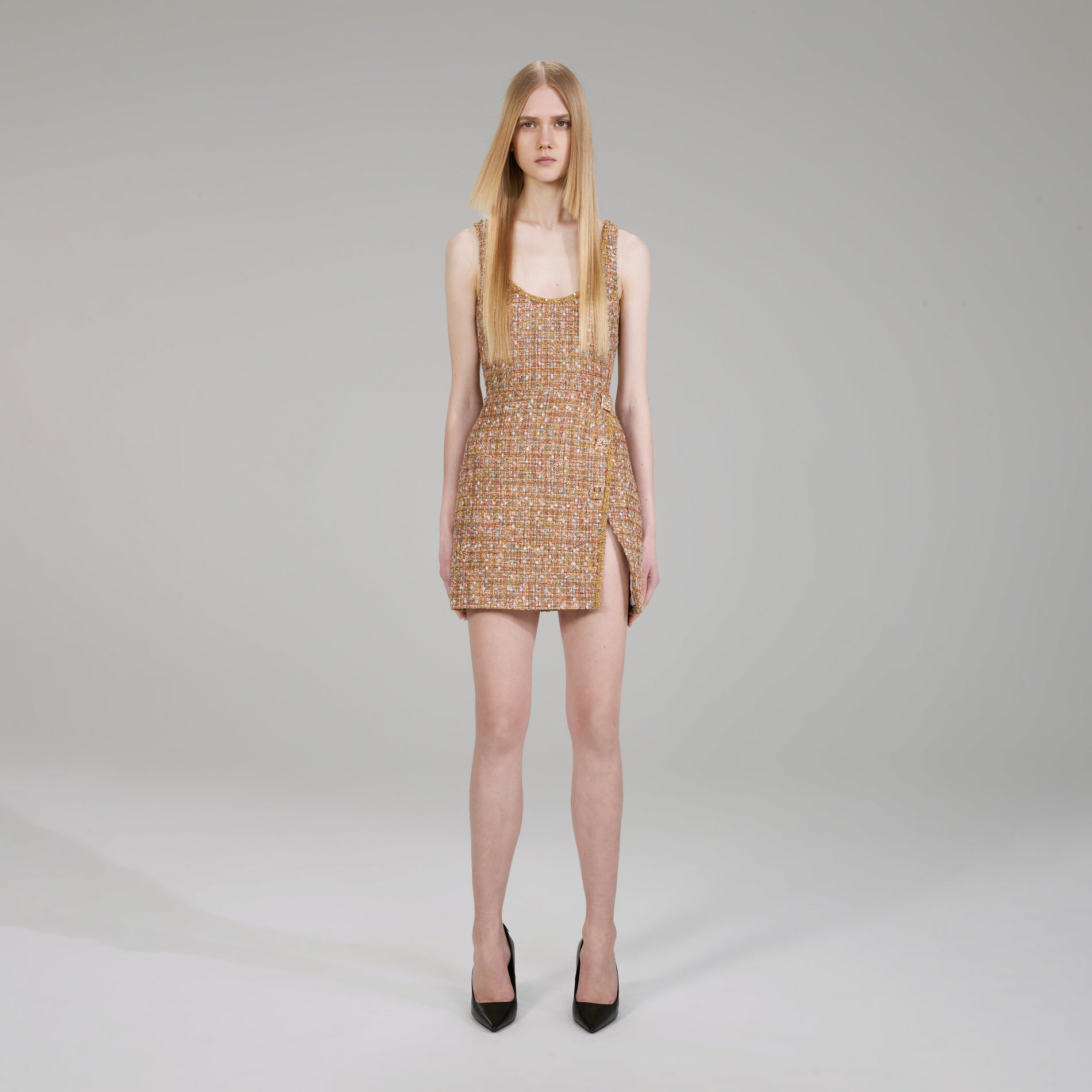 A woman wearing the Gold Tinsel Bouclé Mini Dress