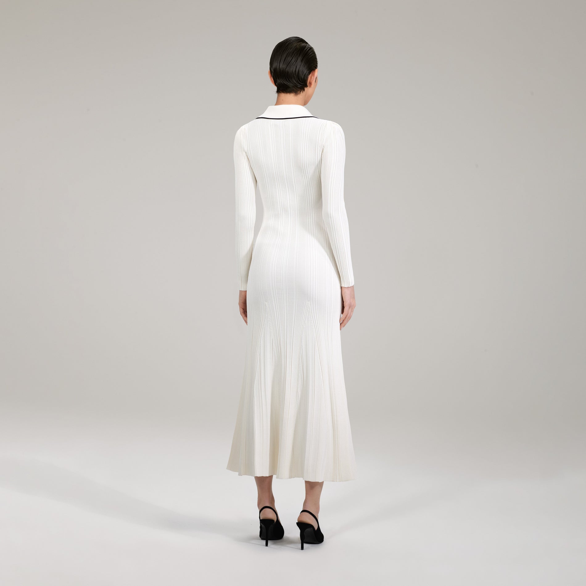 A woman wearing the Ivory Contrast Stitch Knit Dress